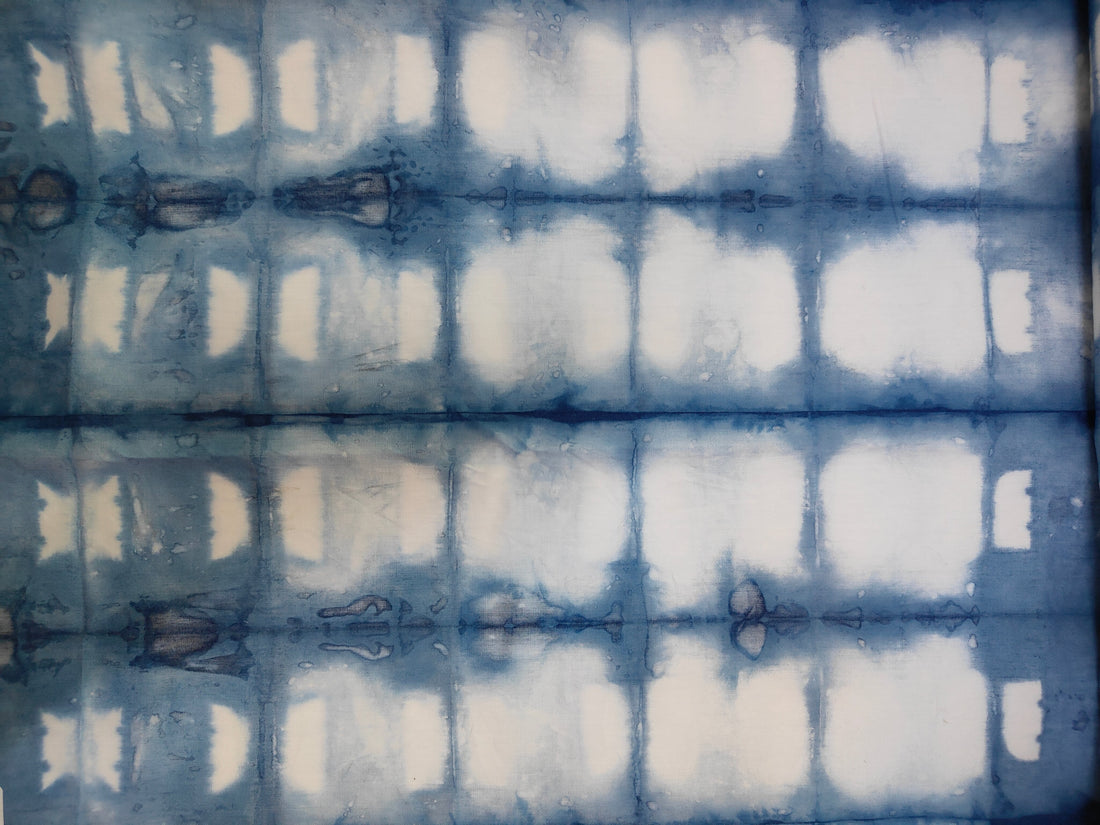 Indigo blue and white Shibori fabric pattern created with traditional folding and dyeing technique by Kokikar