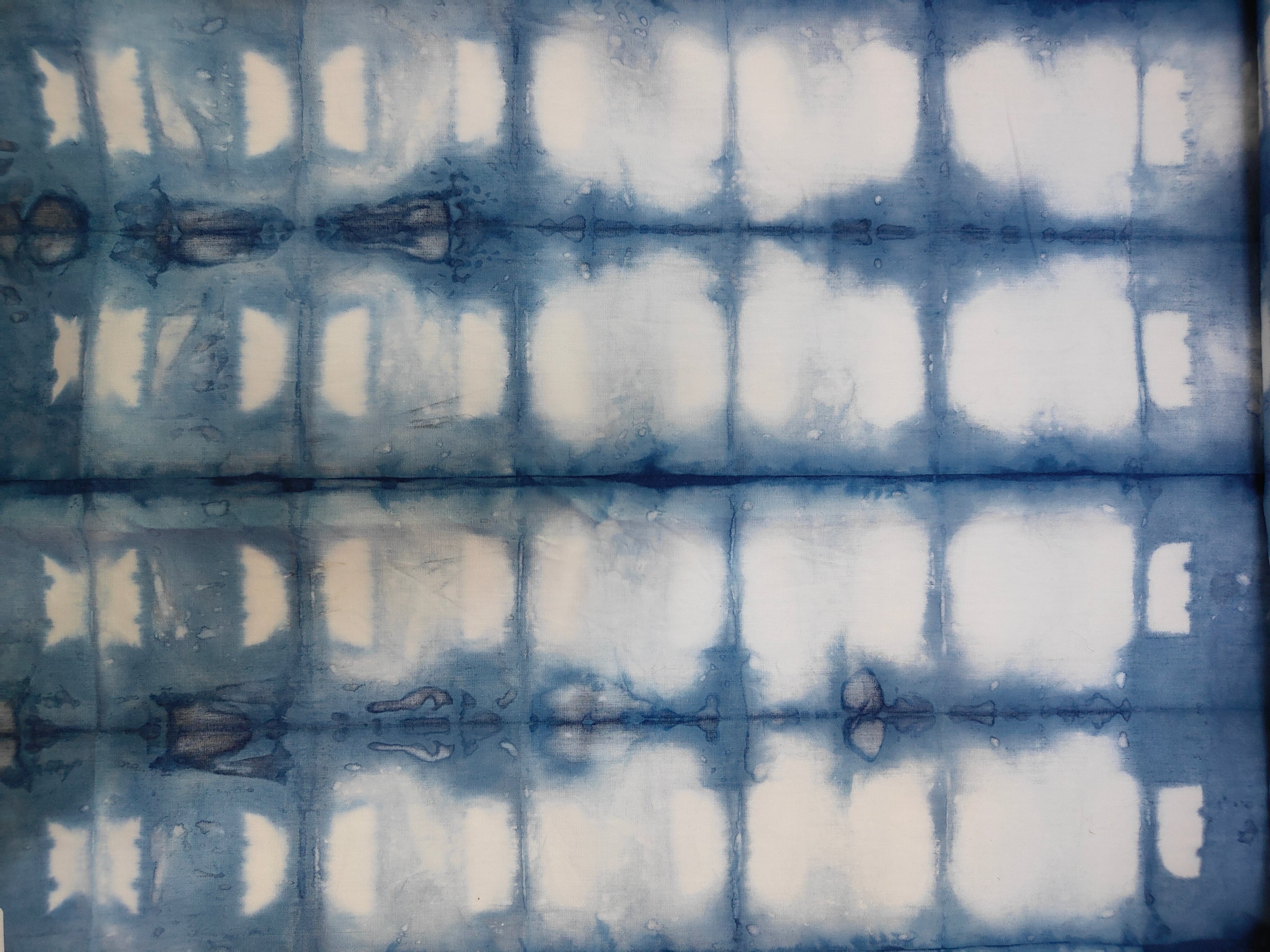 Indigo blue and white Shibori fabric pattern created with traditional folding and dyeing technique by Kokikar