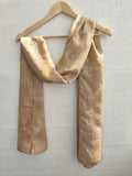 Sunflower Ecoprinted Pure Silk Scarf draped over a wooden hanger against a light gray background