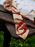 Marbled red and beige tie on a wooden surface with a natural background
