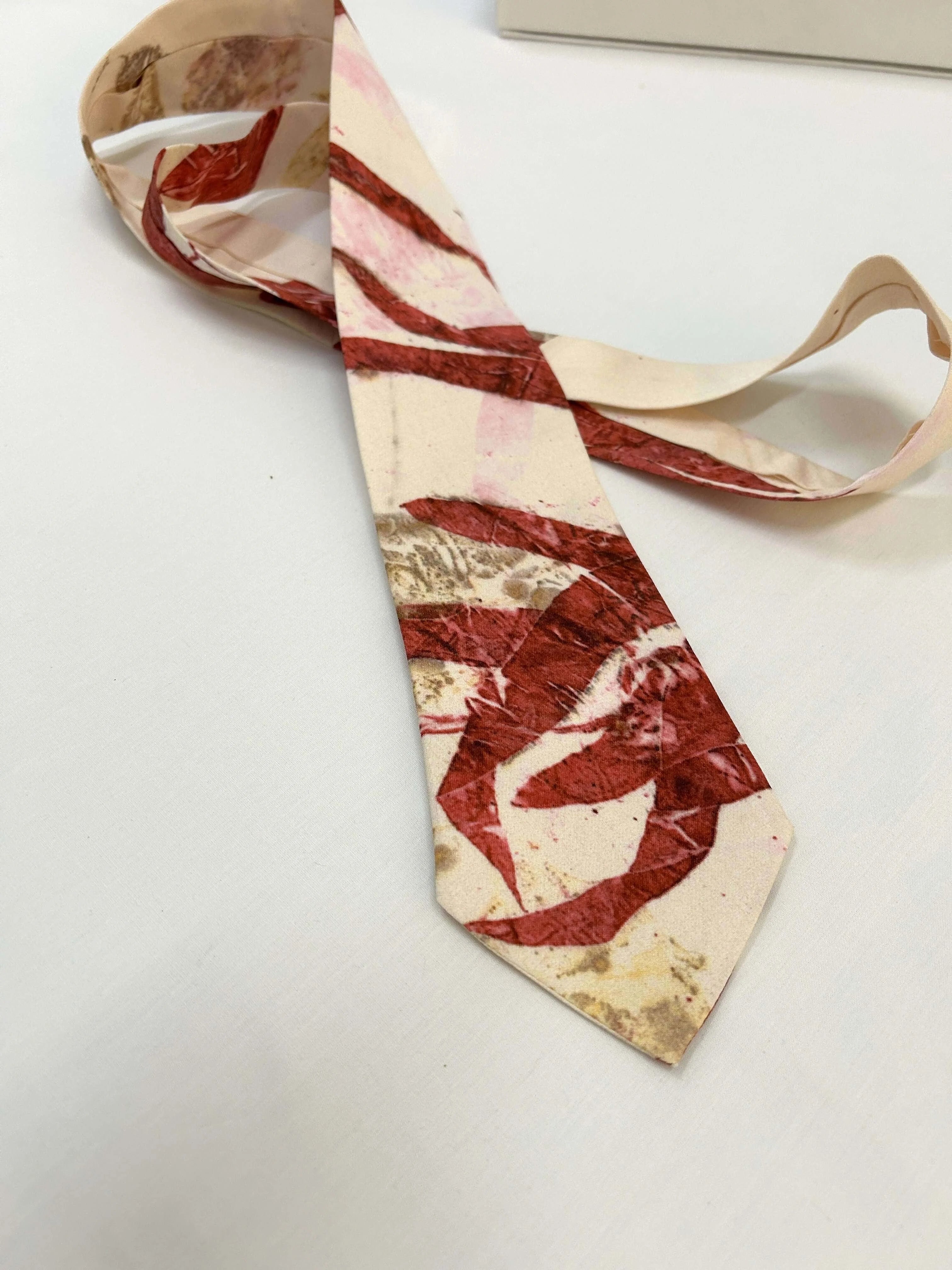 Marbled patterned tie on a white surface