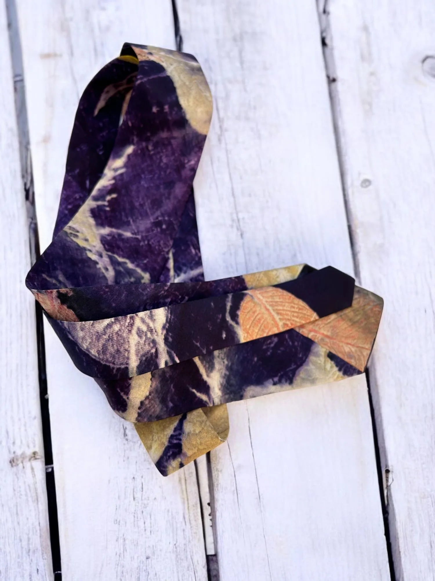 Pure silk mens tie on a wooden surface