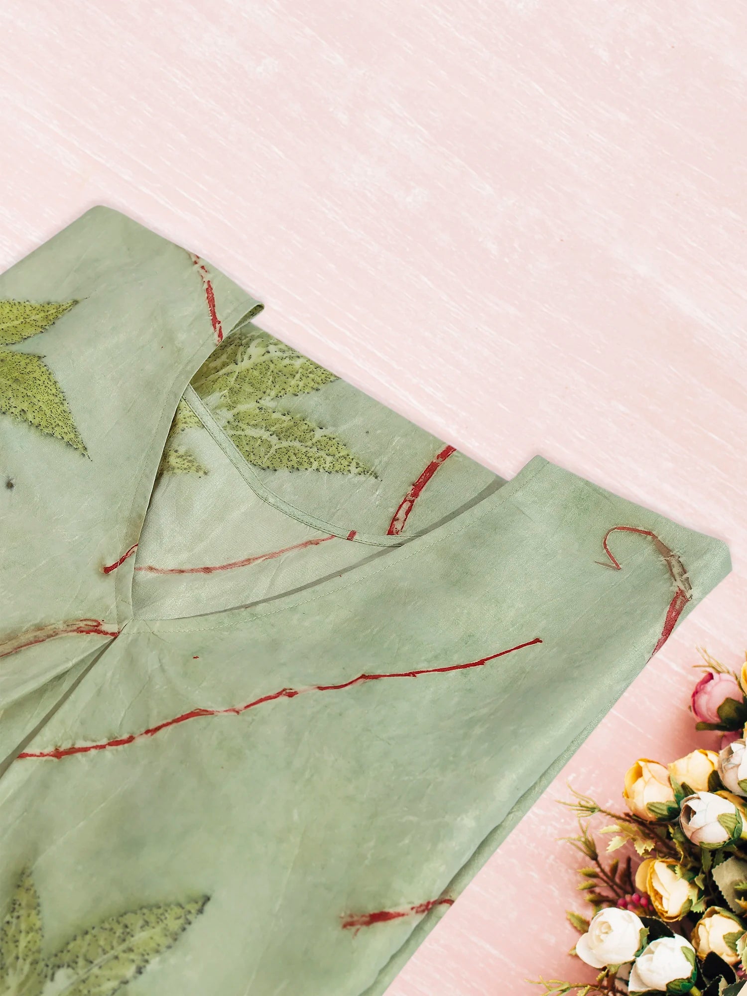 Green ecoprinted kaftan folded on kokikar floor
