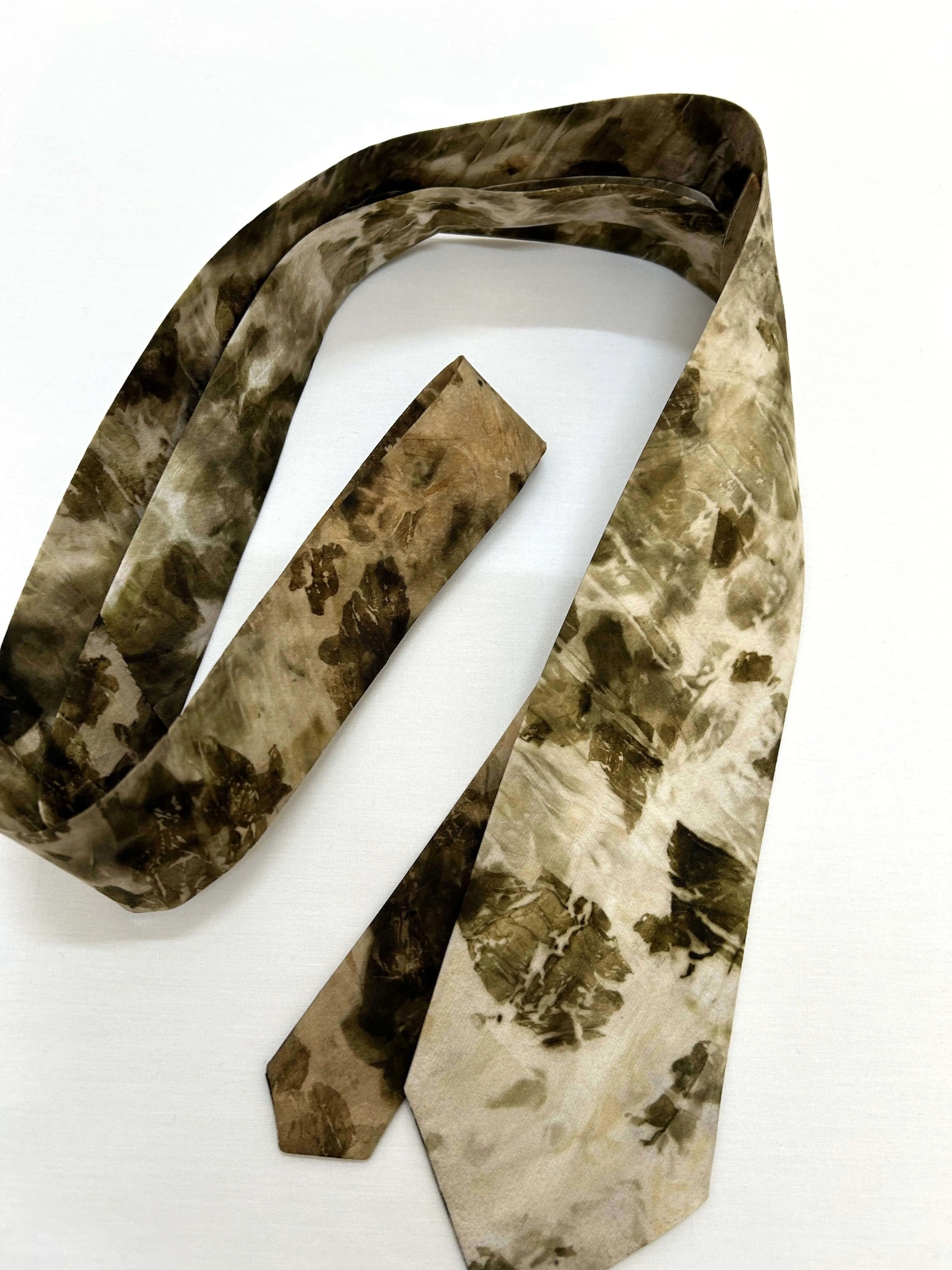 Camouflage-patterned tie on a white background