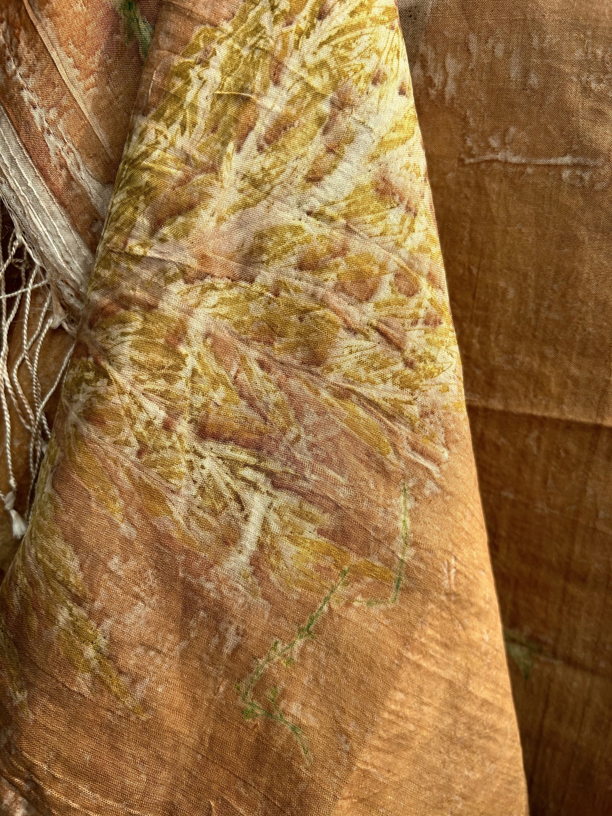 Close-up of a textured brown Coral Carnation Eco Printed Pure Silk Scarf with intricate patterns