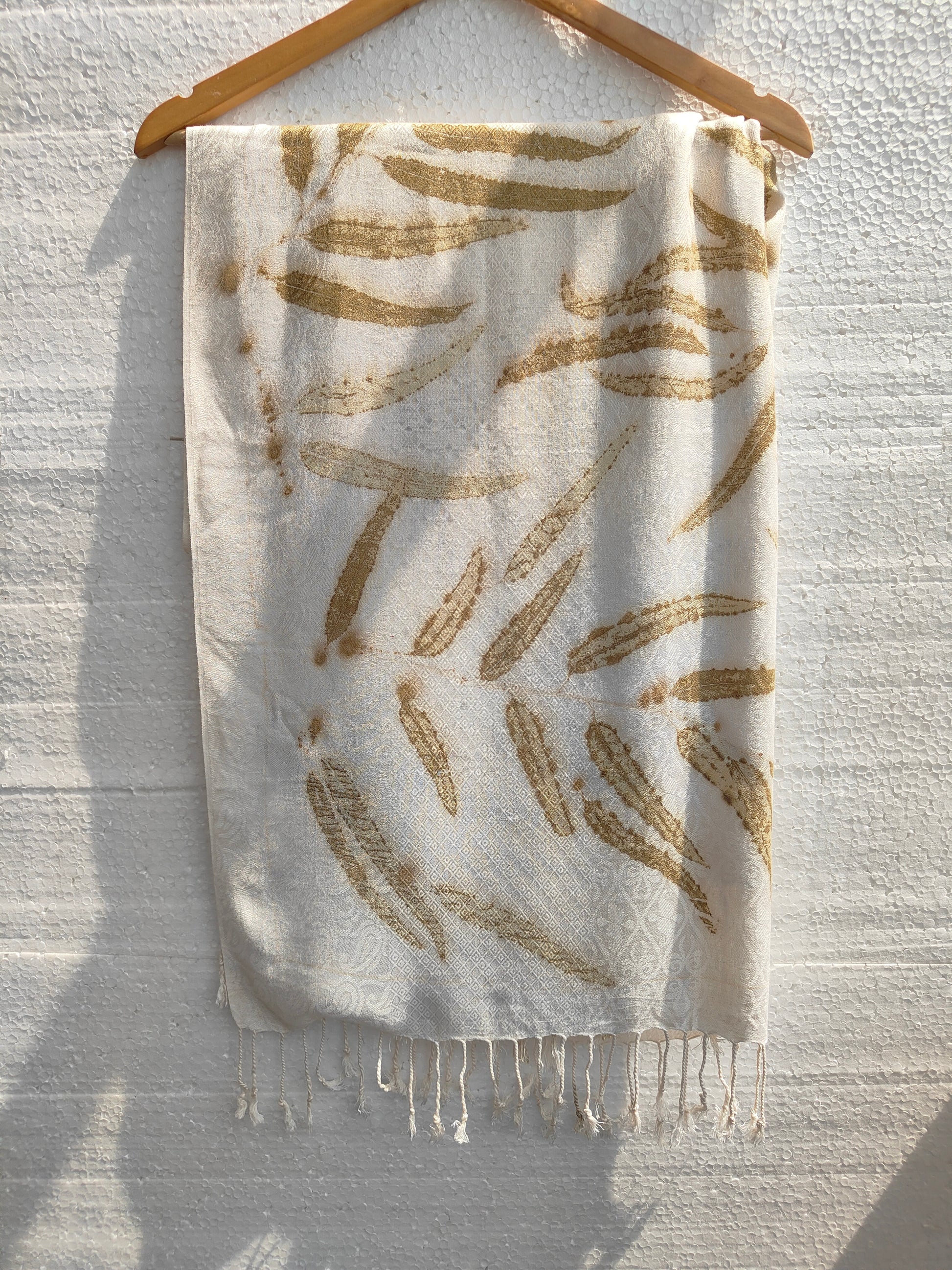 A white viscose scarf ecoprinted with Eucalyptus Leaves