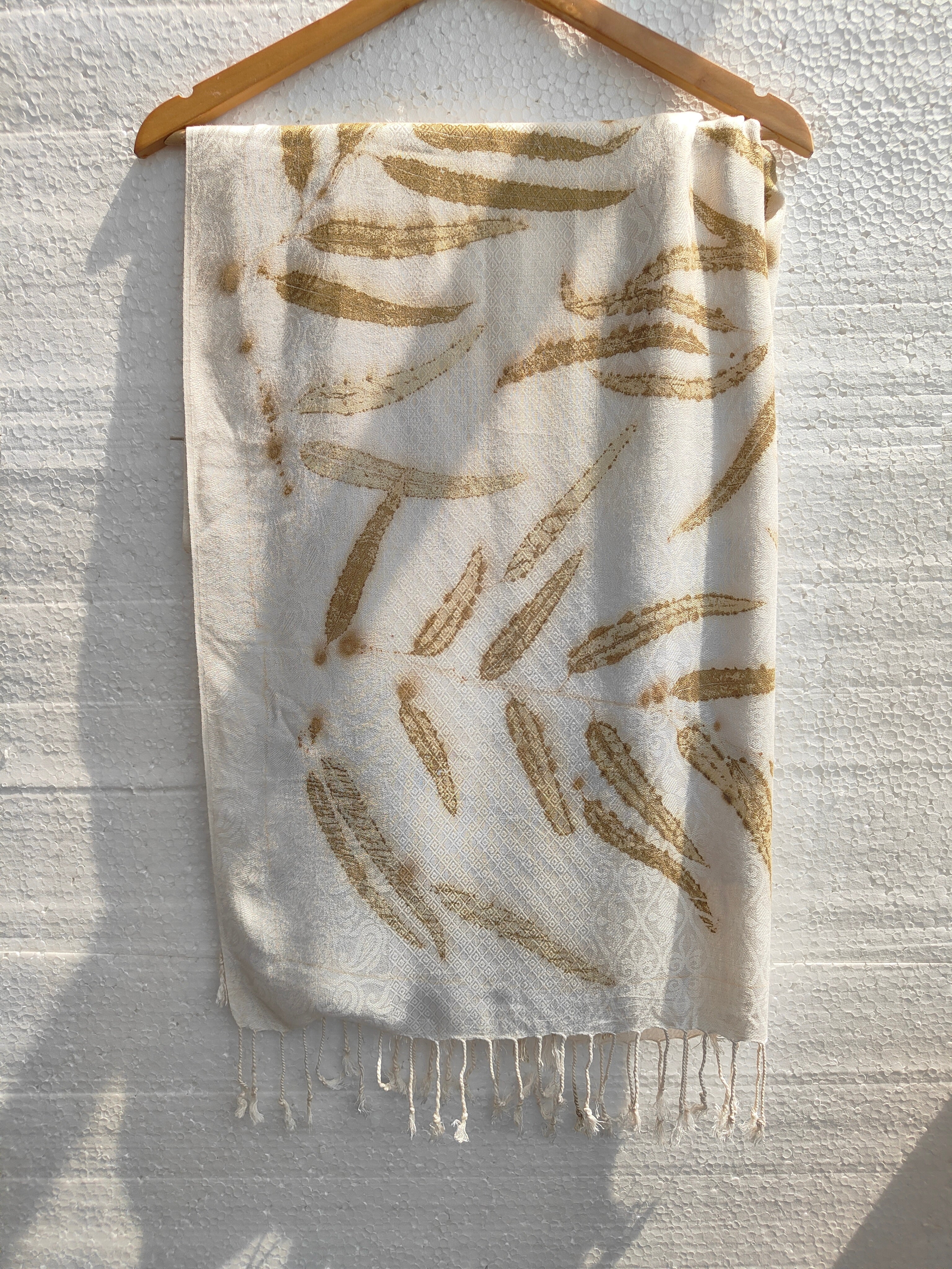 A white viscose scarf ecoprinted with Eucalyptus Leaves