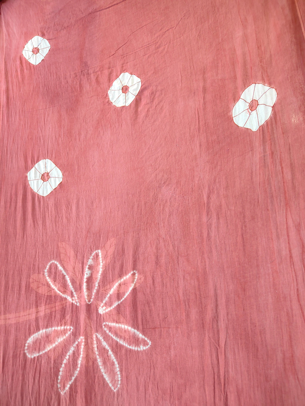 Pink fabric with white floral patterns on ecoprinted saree kokikar