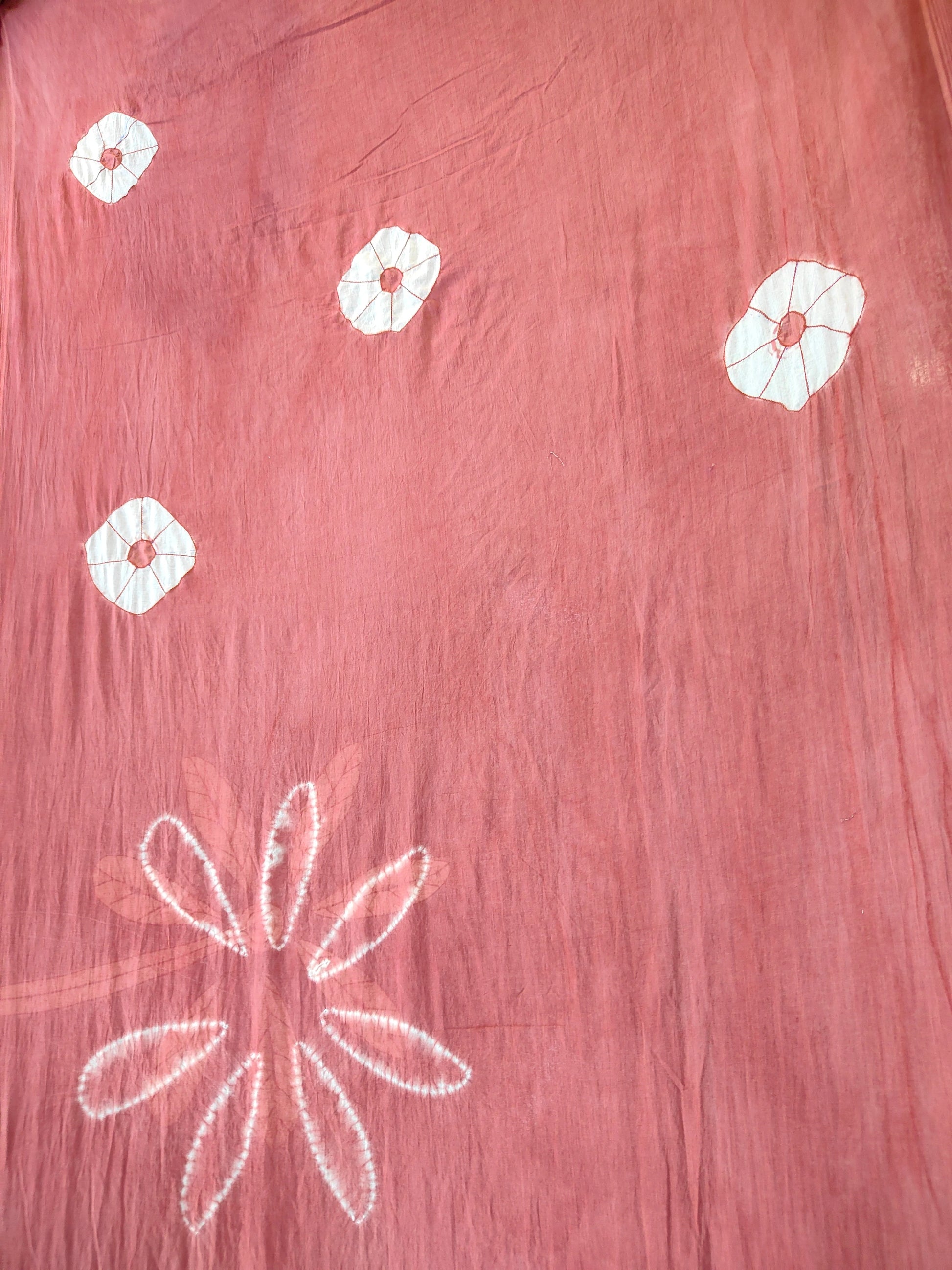 Pink fabric with white floral patterns on ecoprinted saree kokikar