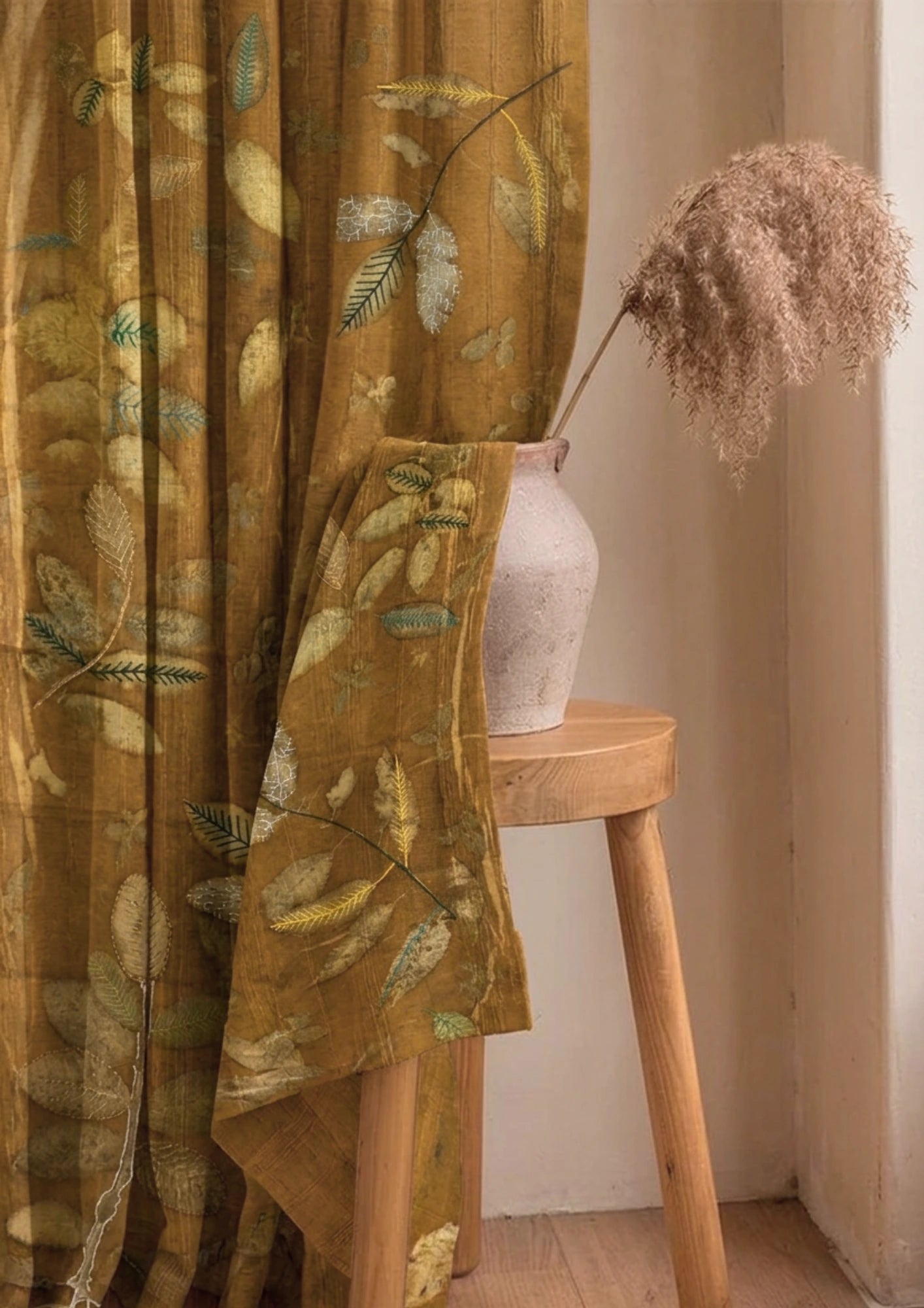 Brown Marigold dyed linen curtain with colorful embroidered leaves, handcrafted botanical home décor and sustainable window treatment curtain with a wooden stool and vase in a room setting