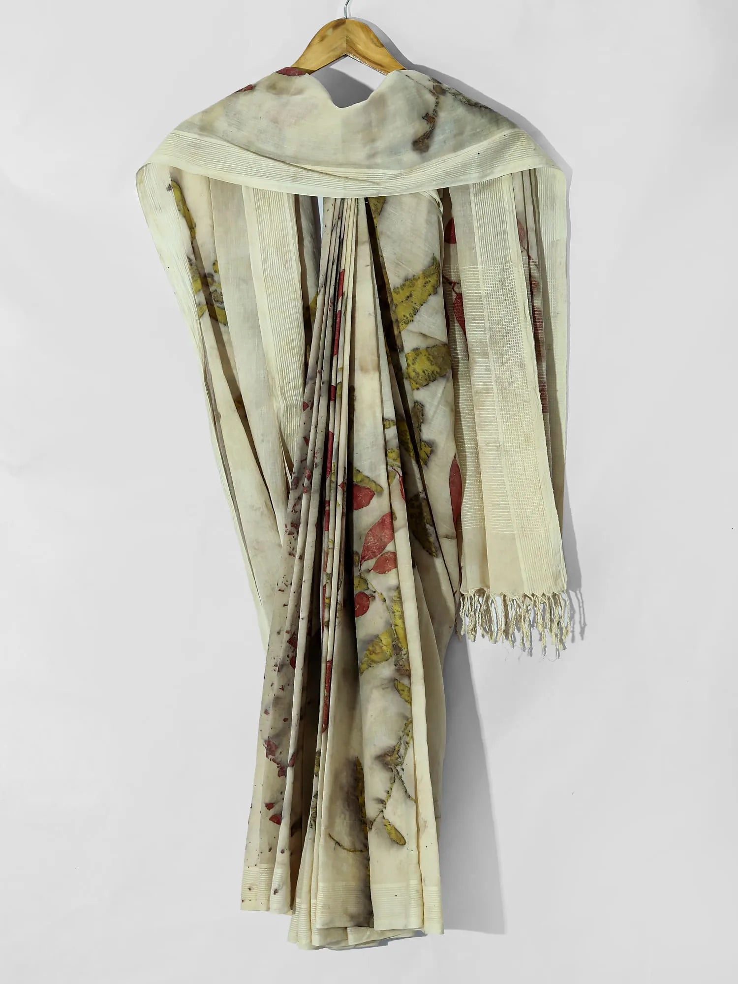 A draped white ecoprinted cotton saree.