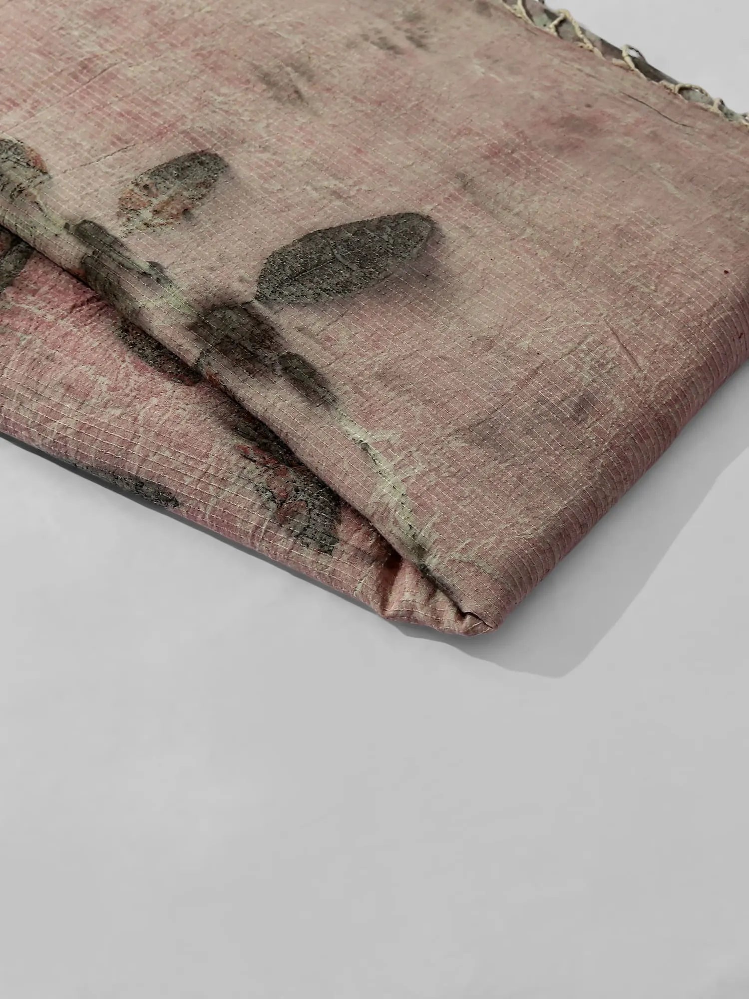 Folded fabric with leaf pattern on a white background kokikar