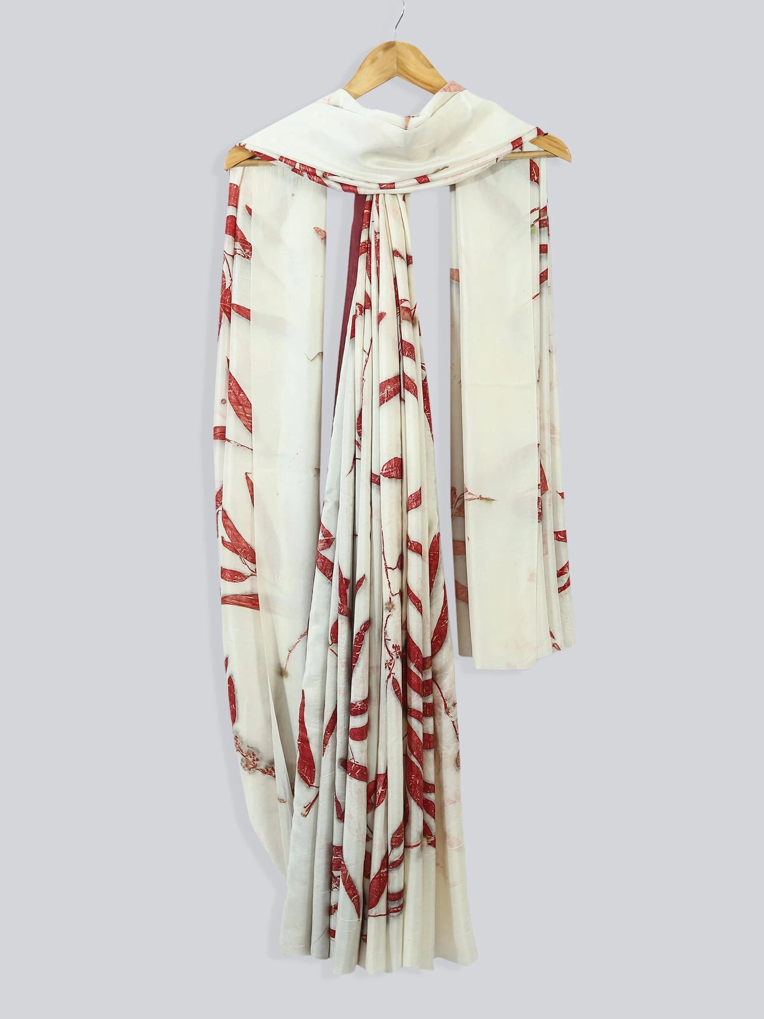 Eucalyptus Ecoprinted Pure Silk Saree drapped against the wall