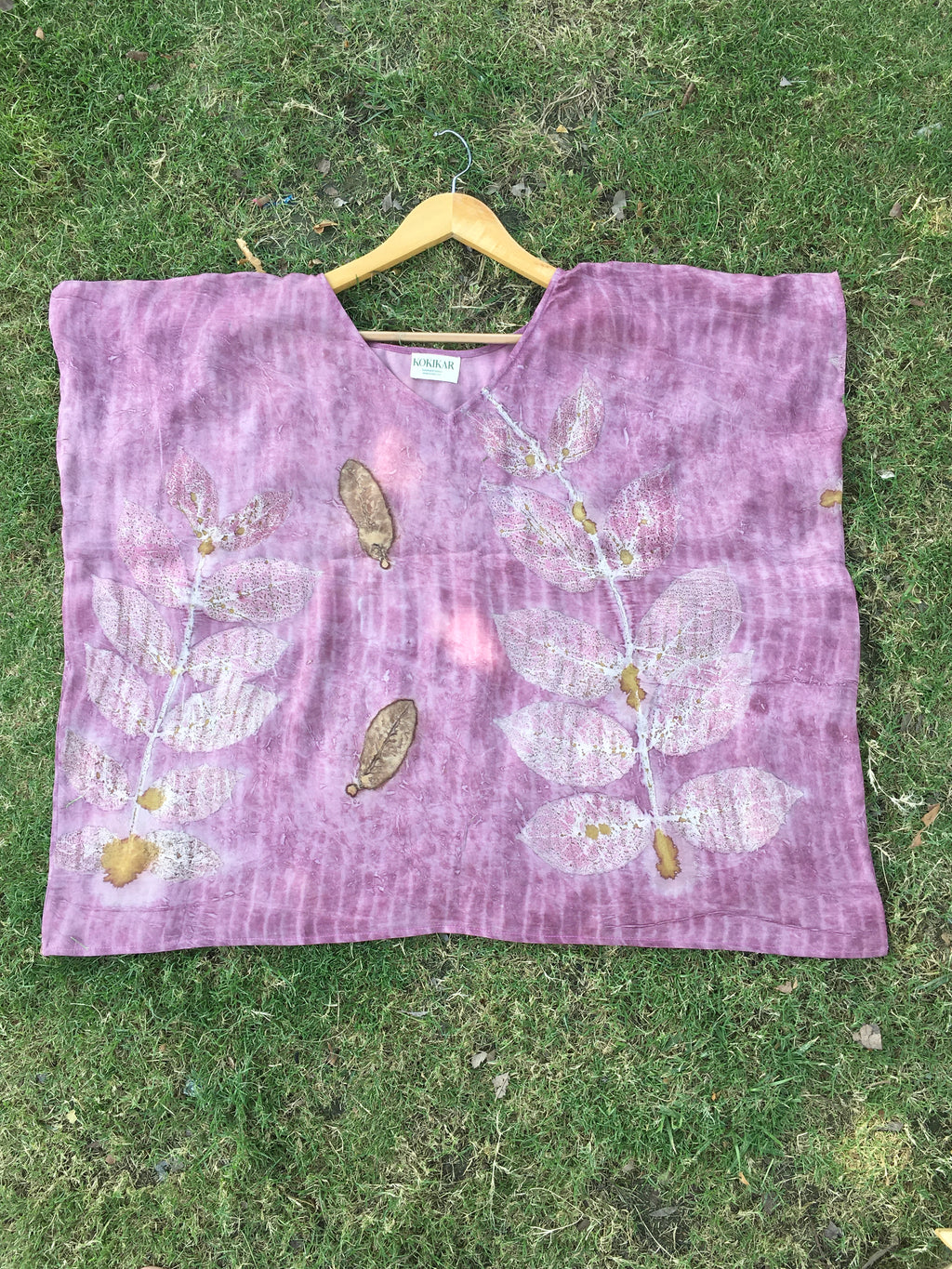 Kaftan Flared Top with floral patterns on a grassy background
