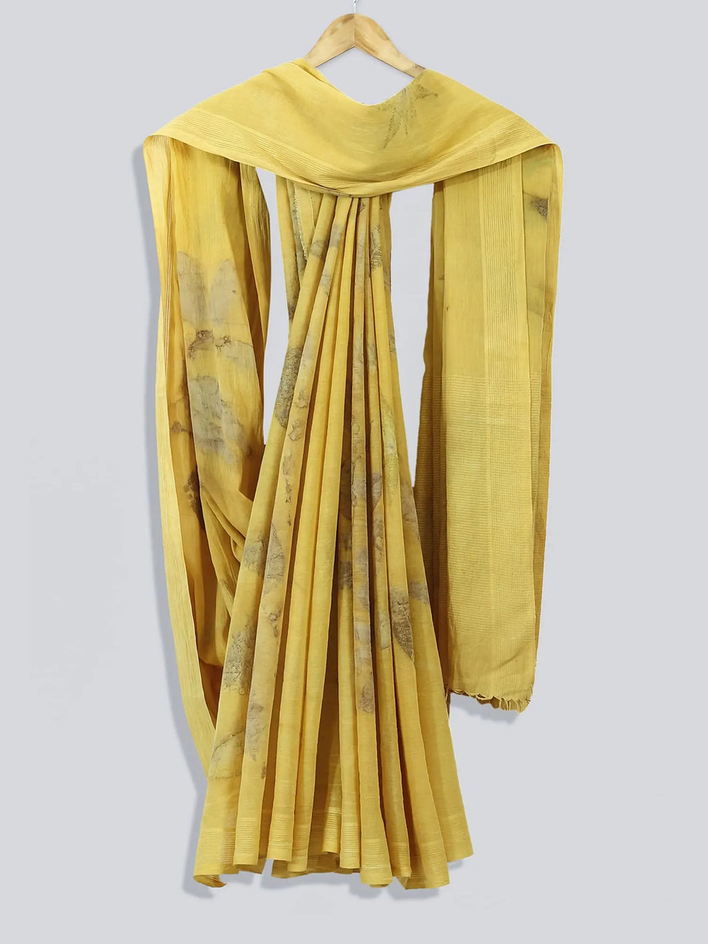 Yellow saree with a floral pattern on a gray background
