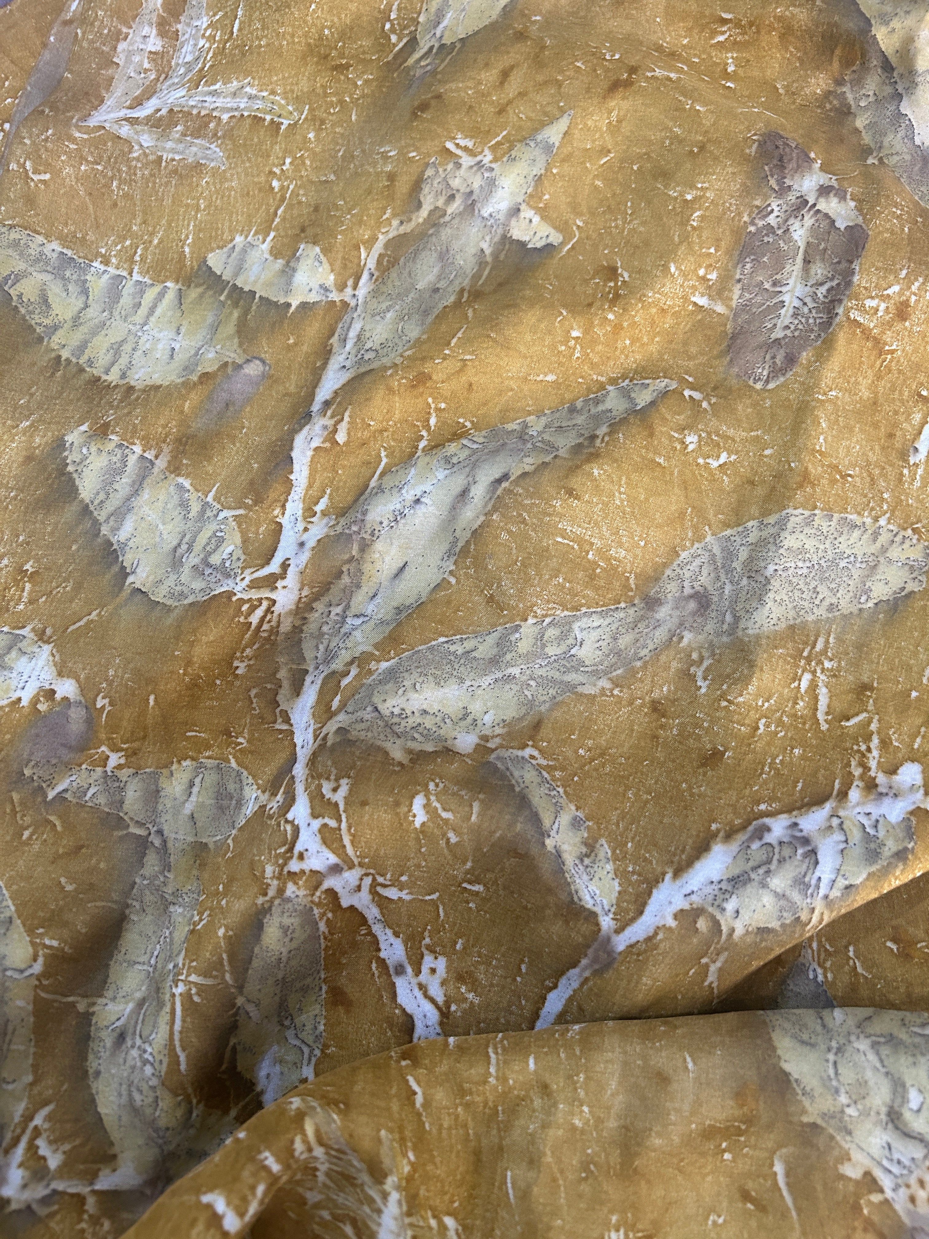 A yellow silk fabric with ecoprinted Eucalyptus