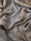 A grey fabric with ecoprinted guava leaf