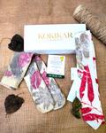 Two pairs of socks with leave patterns on a textured surface, featuring the Kokikar brand Heritage Ecoprinted Gift Hamper