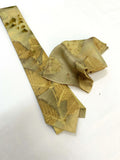 Gold patterned tie on a white background