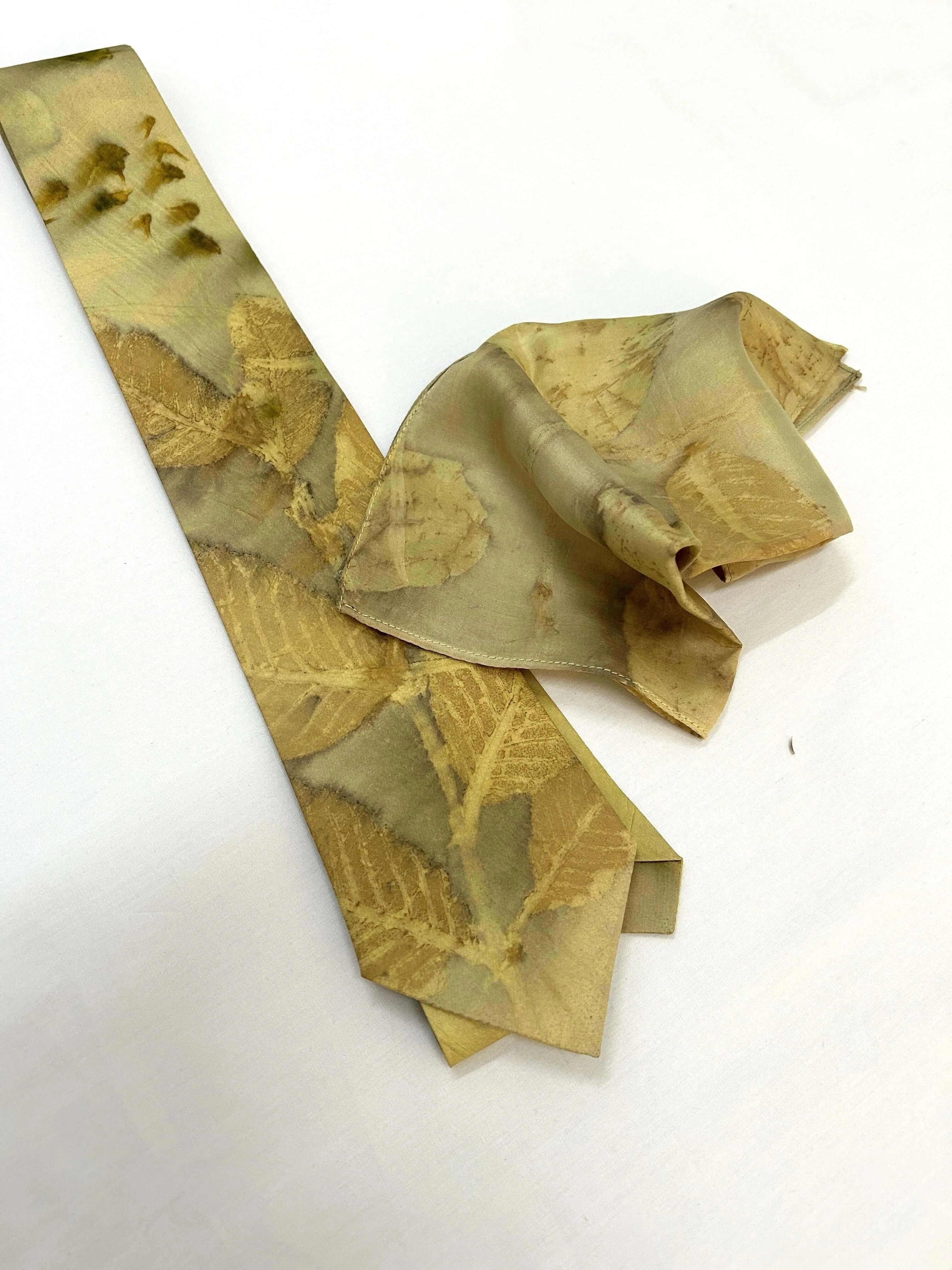 Gold patterned tie on a white background