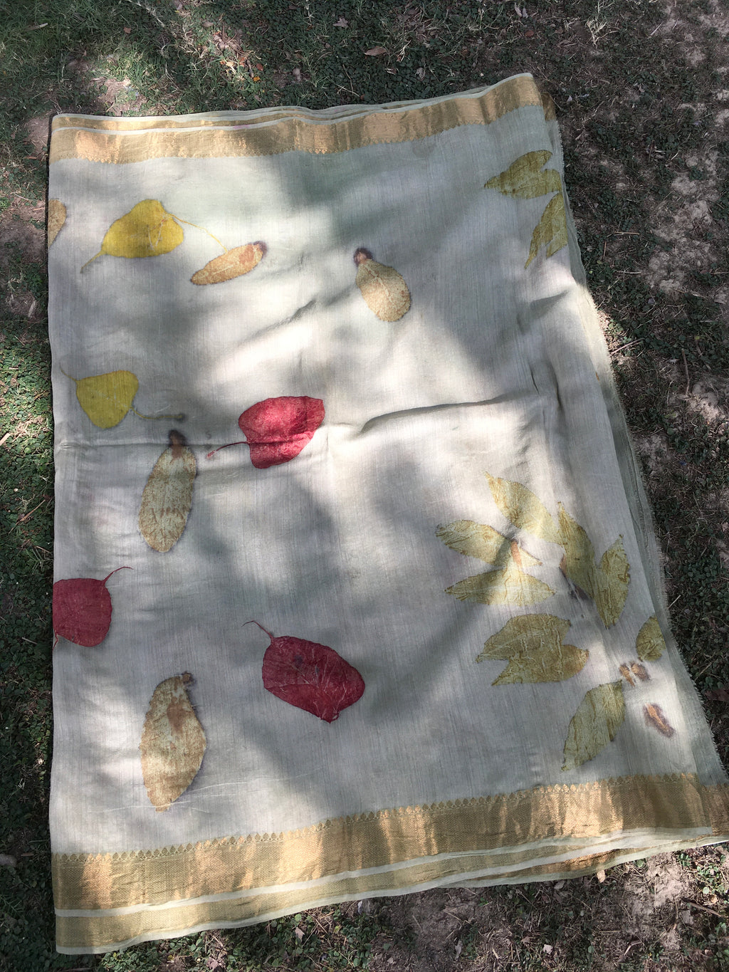 Ecoprinted Matka Silk Saree with leaf pattern on a textured surface