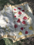 Matka Silk Saree with red and yellow leaf pattern on a textured surface