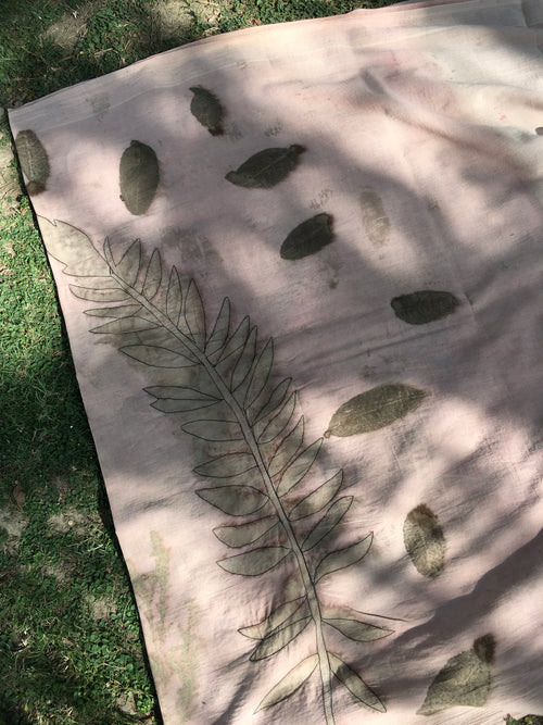 ecoprinted cotton saree with leaf pattern on a grassy background