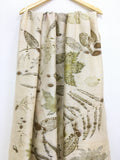 Botanical Eco Printed Pure Silk Scarf with leaf pattern hanging on a wooden hanger against a white background