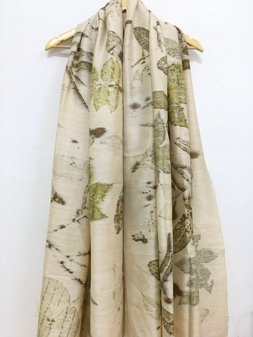 Botanical Eco Printed Pure Silk Scarf with nature-themed design draped over a wooden hanger on a white background