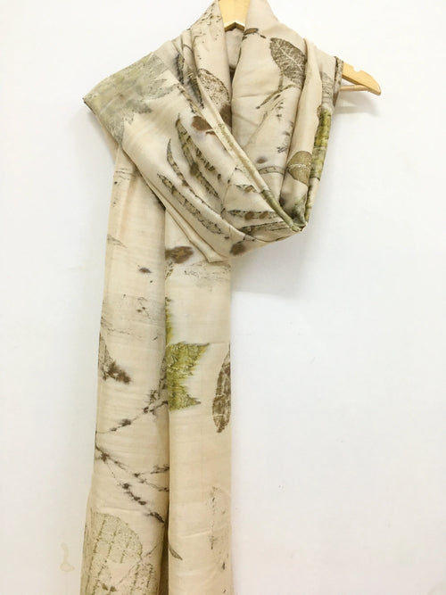 Botanical Eco Printed Pure Silk Scarf with leaf pattern on a wooden hanger against a white background
