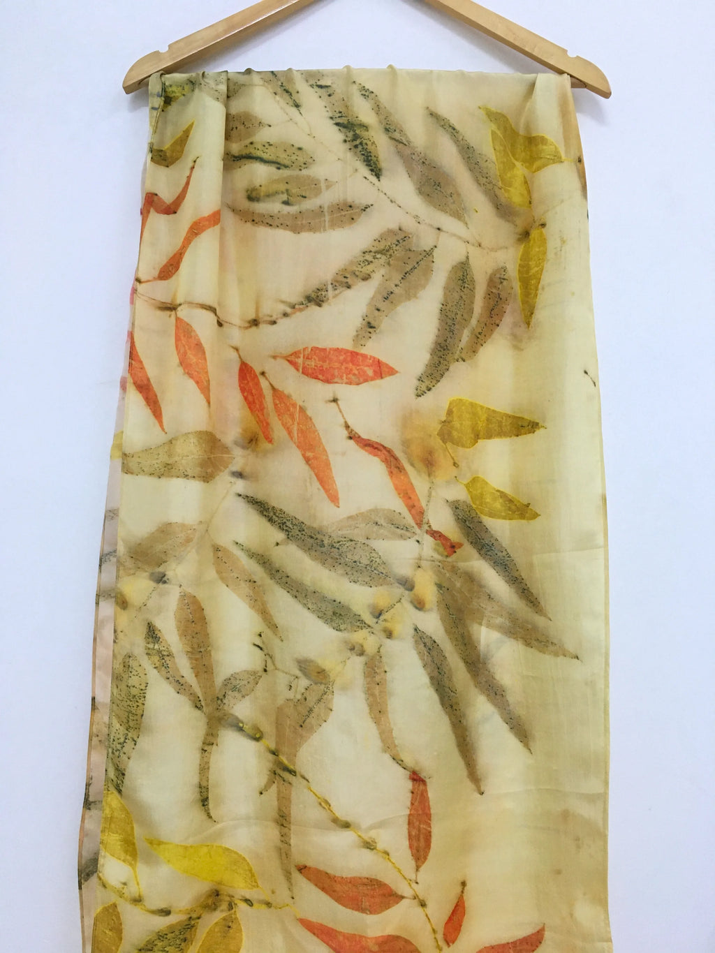 Golden Eucalyptus Eco Printed Pure Silk Scarf with leaf pattern on a white background