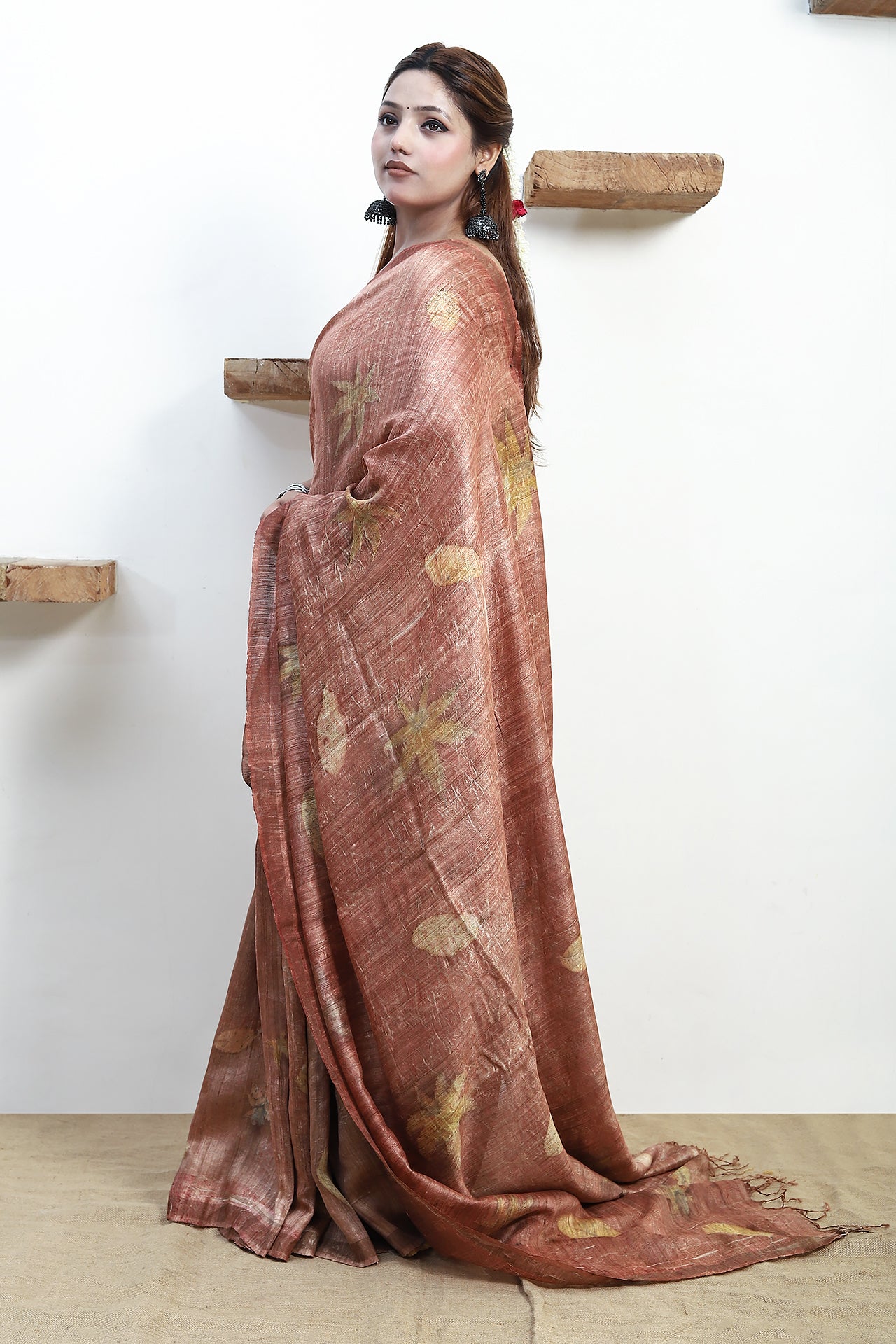 Woman wearing a pure matka silk saree with a white background