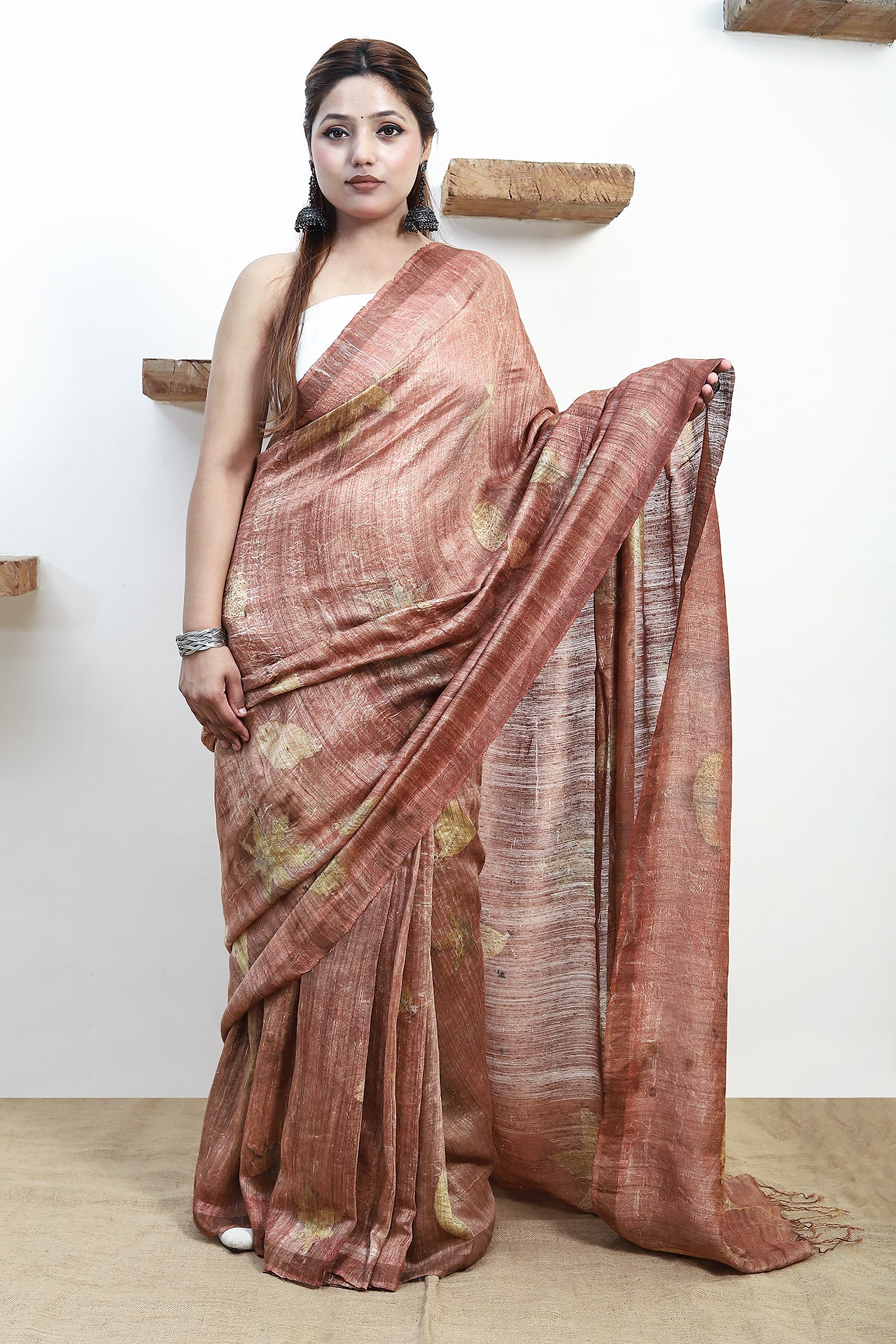 Woman wearing a pure matka silk saree with a white background