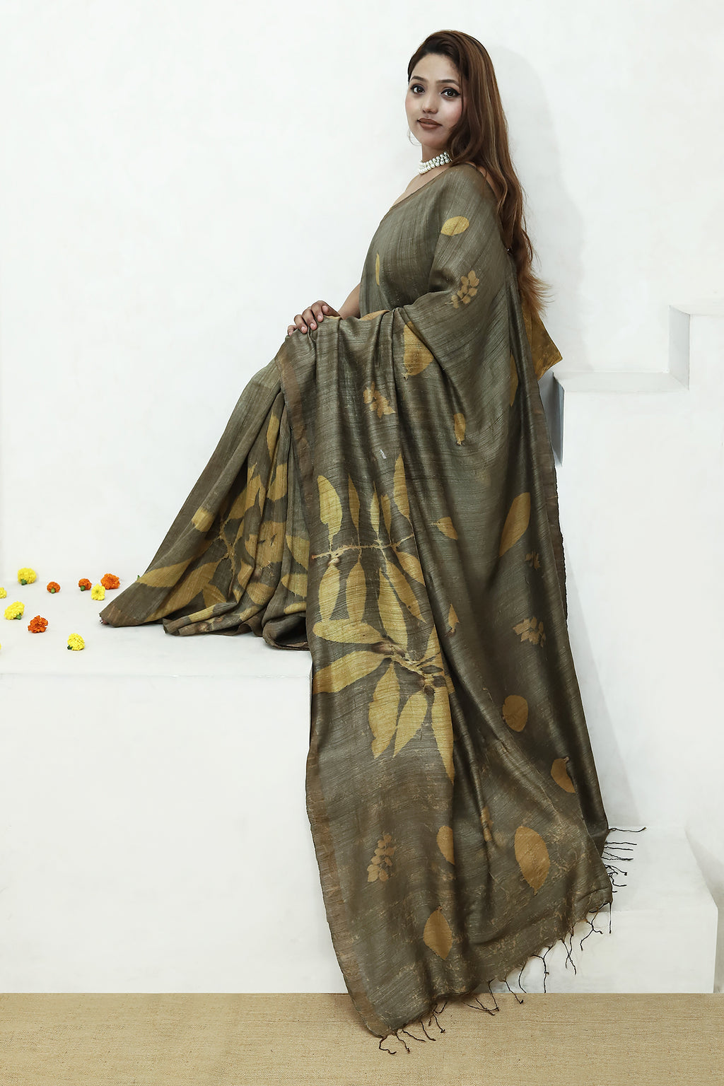 Woman wearing a green ecoprinted pure matka silk saree against a white background