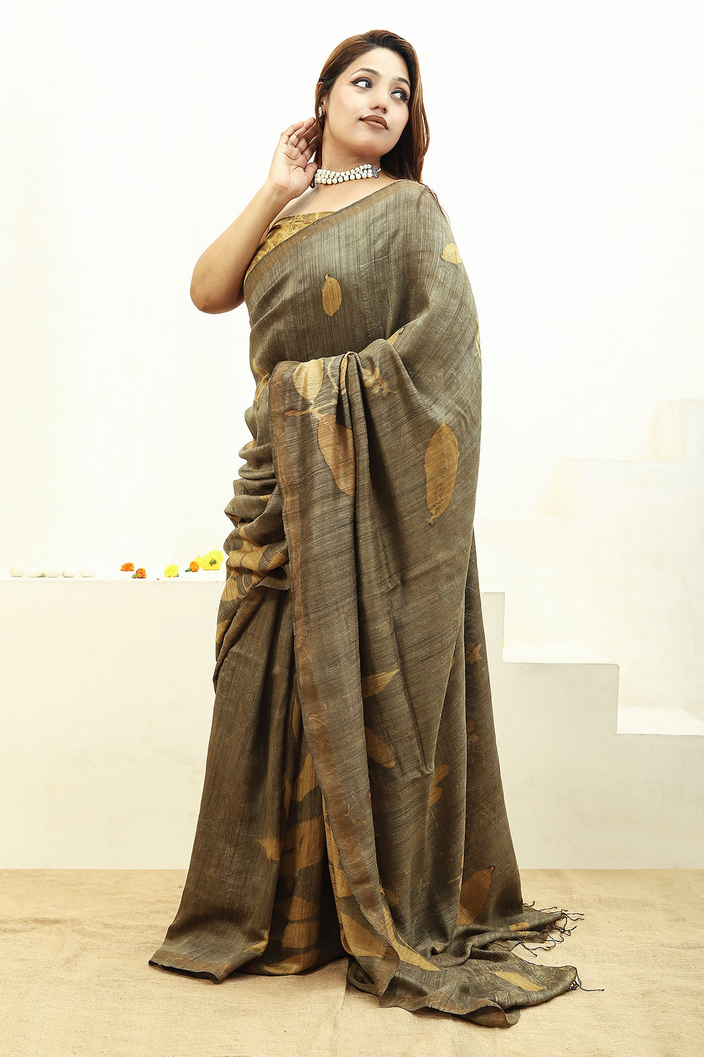 Woman wearing a Jamun Ecoprinted pure matka silk saree with a plain background