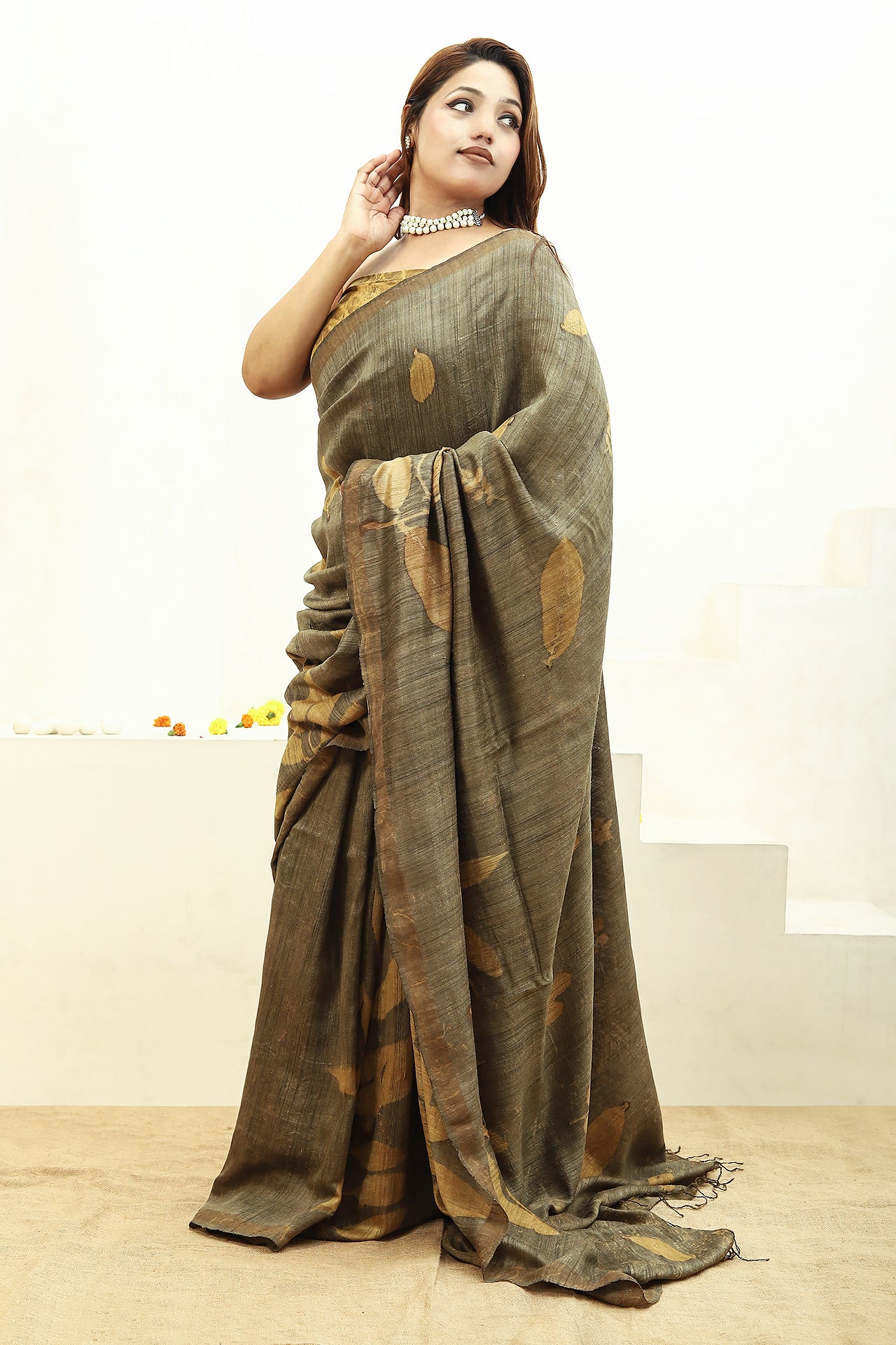 Woman wearing a Jamun Ecoprinted Matka Silk saree with a plain background