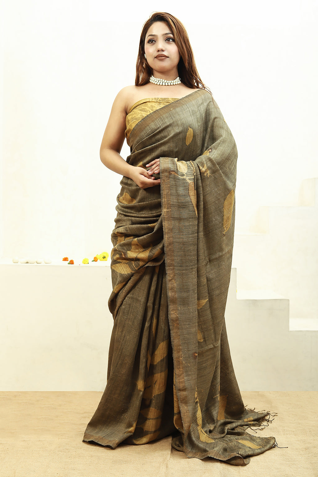 Woman wearing a Jamun Ecoprinted pure matka silk saree with a plain background