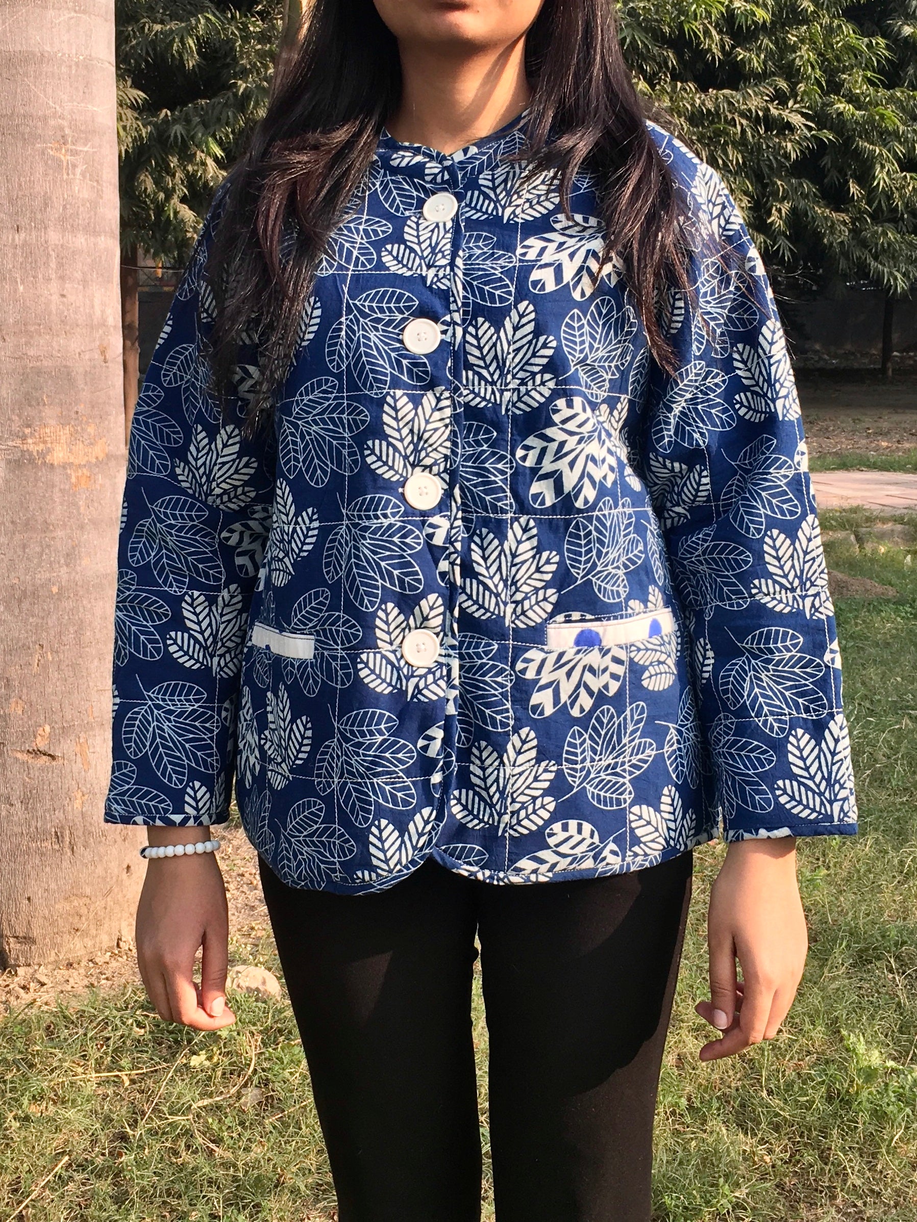 women wearing a blue patterned reversible jacket outdoor