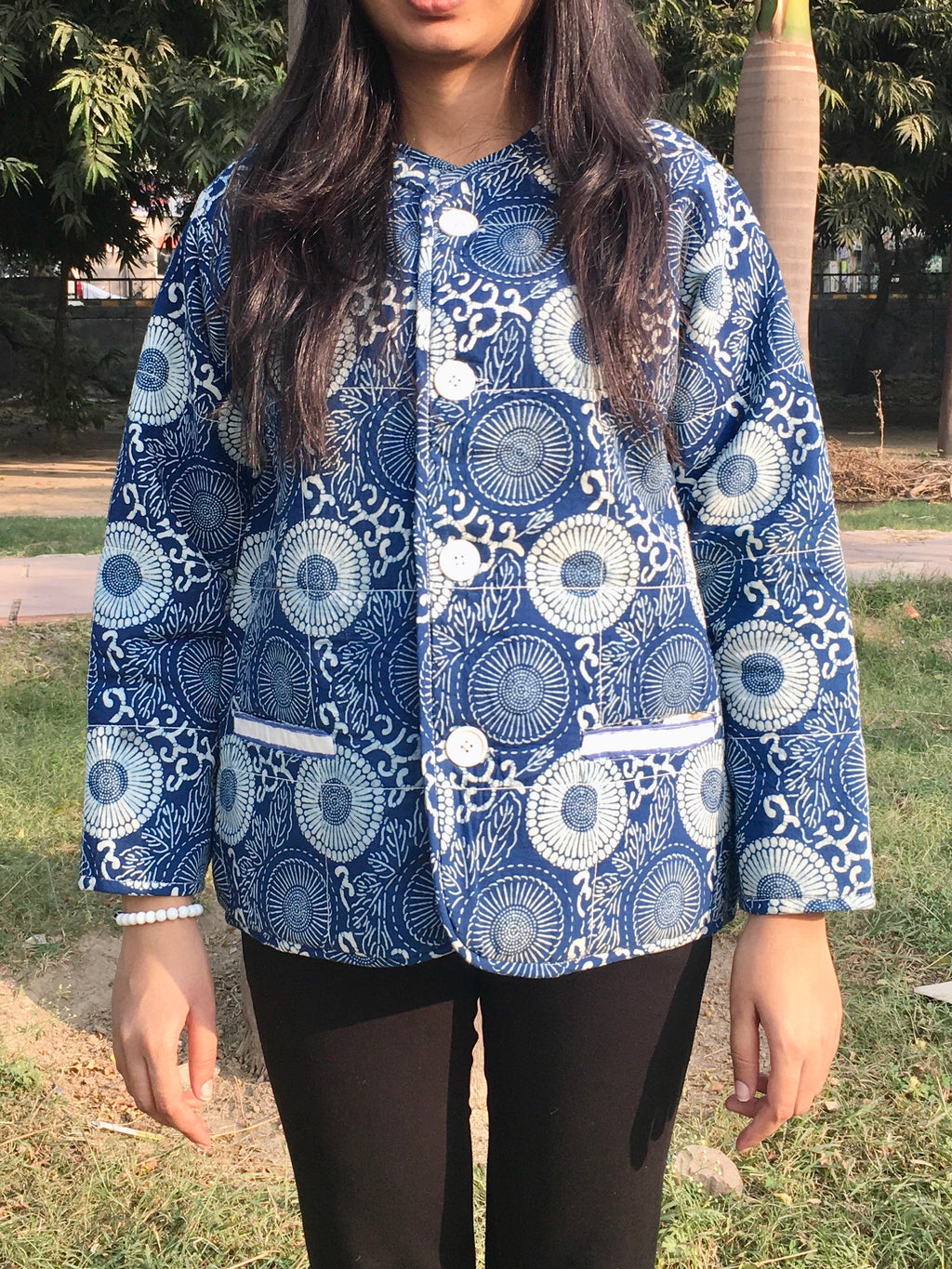 women wearing a blue and white patterned reversible jacket outdoors