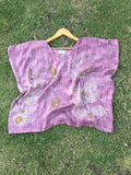 pink Kaftan Flared Top with floral patterns on a grassy background