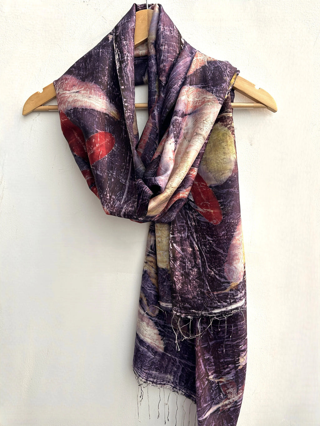 Lavender Ecoprinted Pure Silk Scarf draped over a wooden hanger on a white background