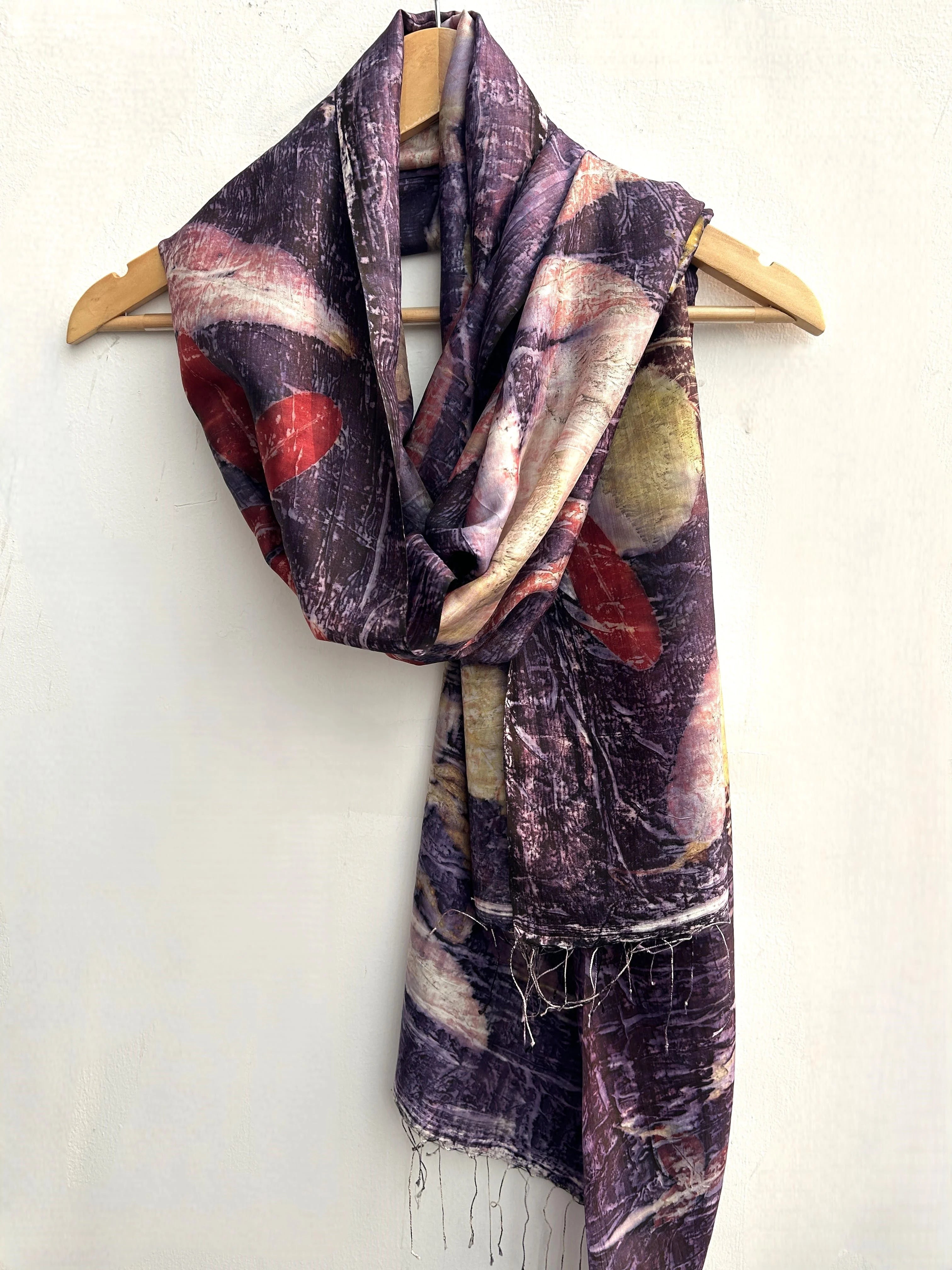 Lavender Ecoprinted Pure Silk Scarf draped over a wooden hanger on a white background