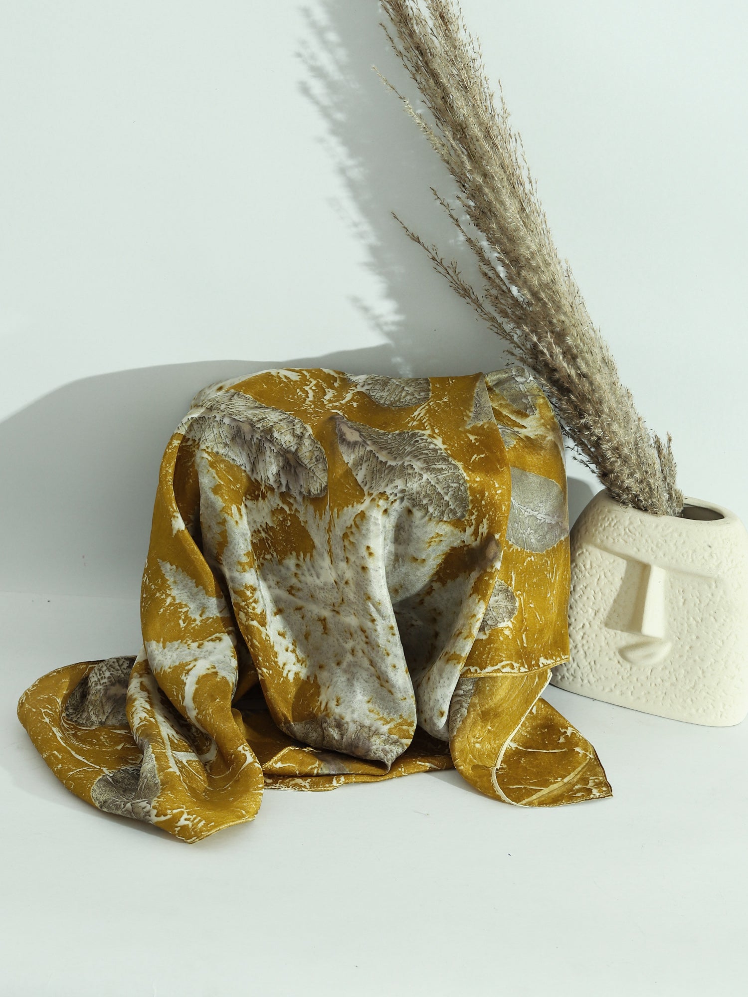 A mustard color sqare scarf