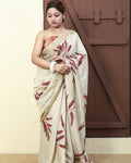 Woman wearing a Madder Drape Muga Silk Saree with red floral patterns against a neutral background