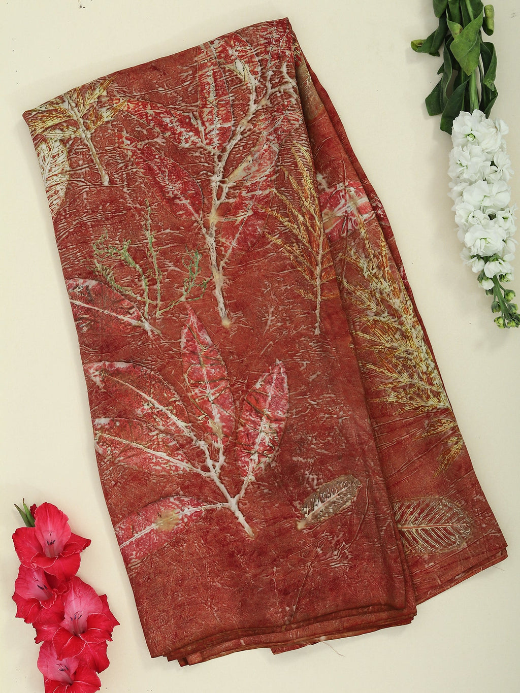 A folded maroon silk saree