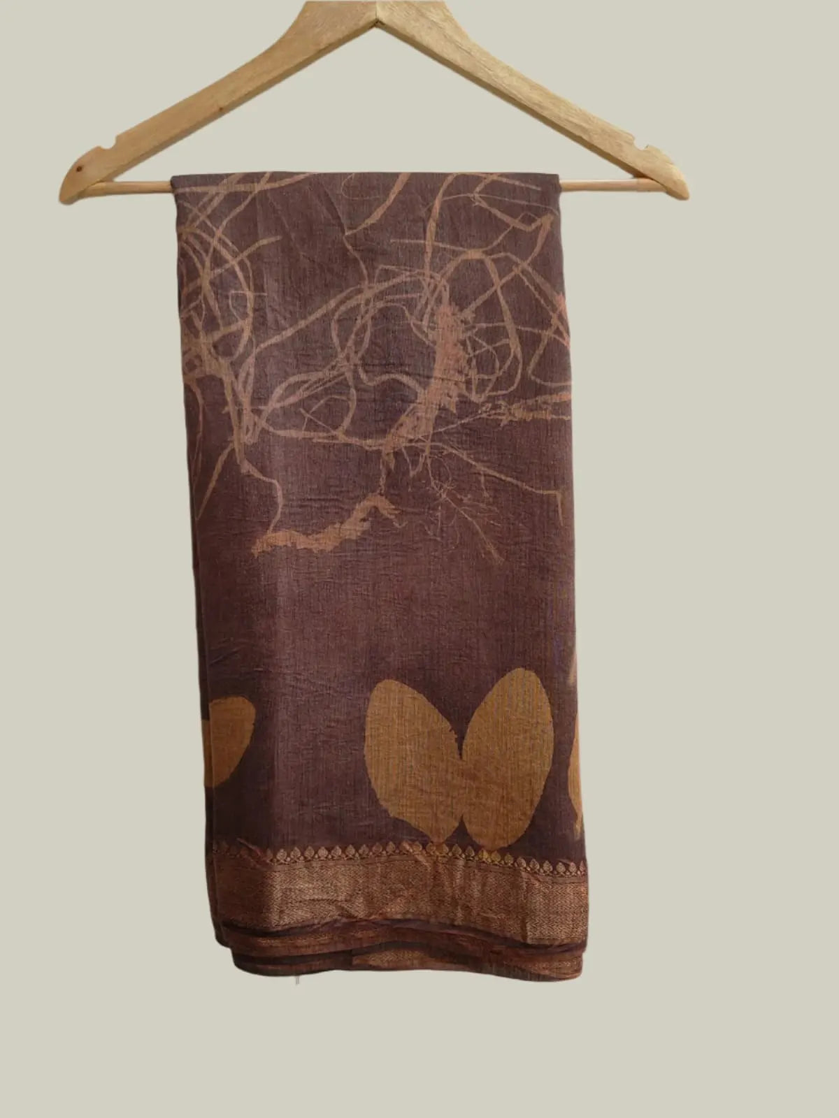 Brown muga silk saree on hanger 