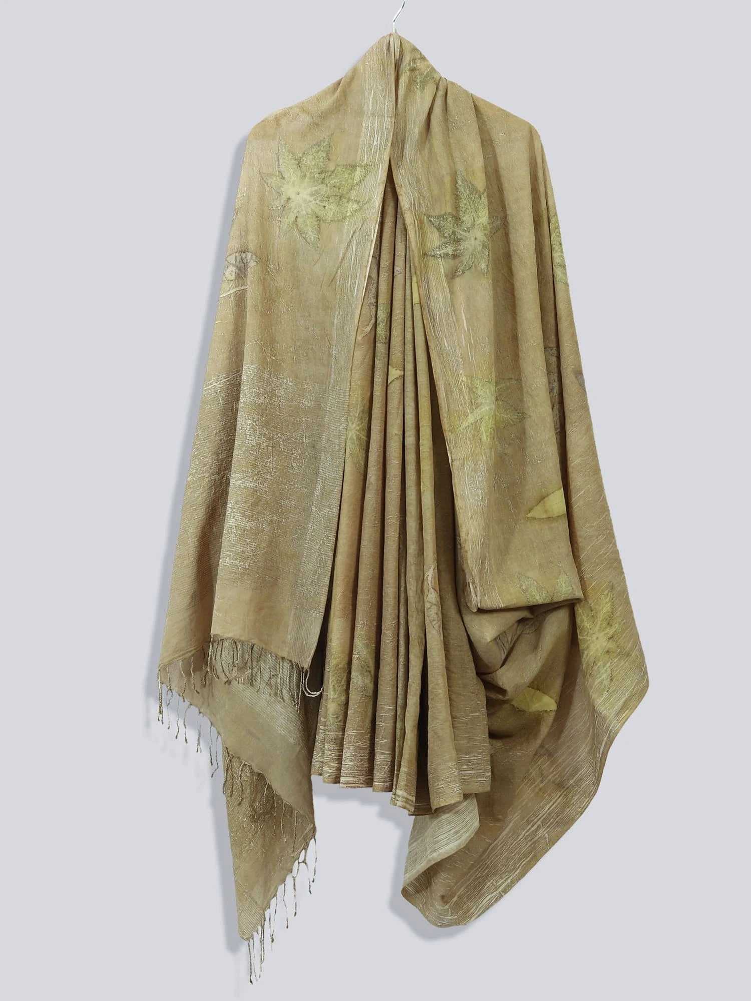 Naturally Dyed Mulmul Ecoprinted Saree by kokikar hanging against the wall