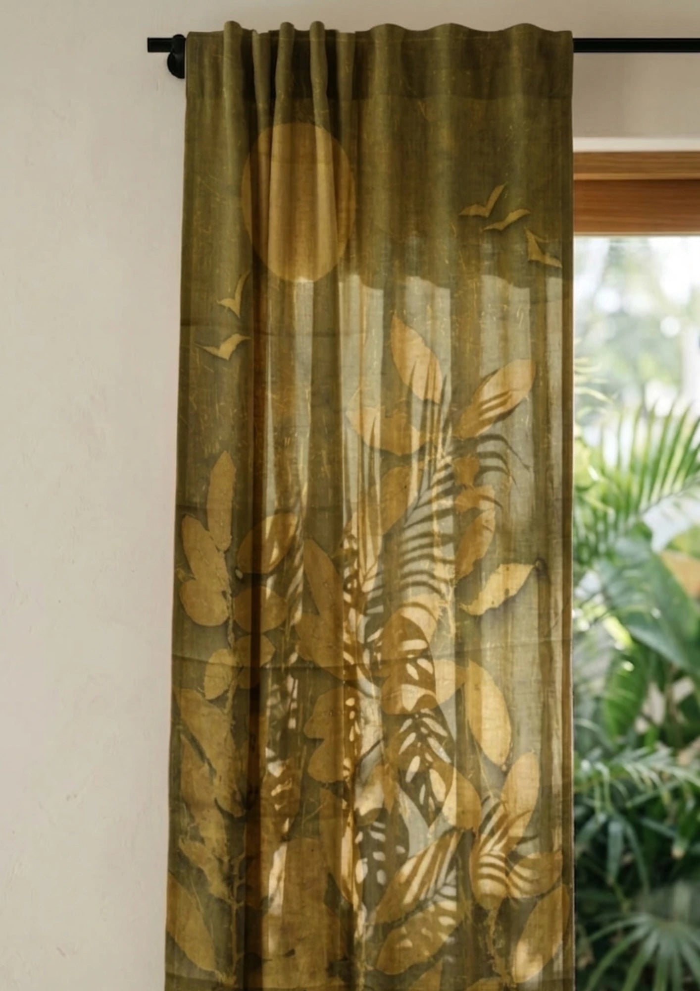 Sheer Myrobalan eco-printed linen curtain with sun, birds, and botanical artwork on premium sustainable linen fabric with leaf pattern in front of a window with outdoor view