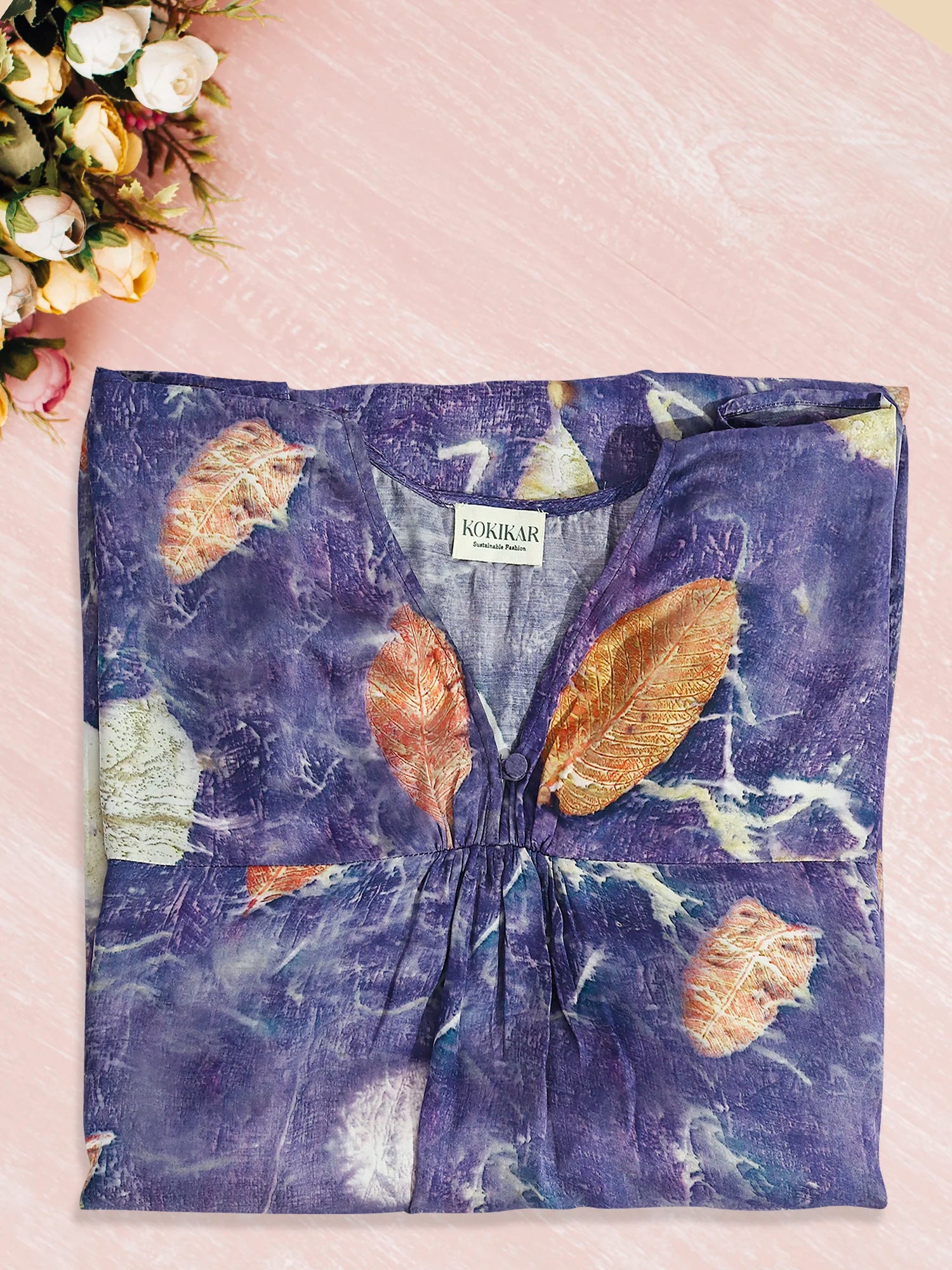 Blue ecoprinted kaftan folded on kokikar floor 