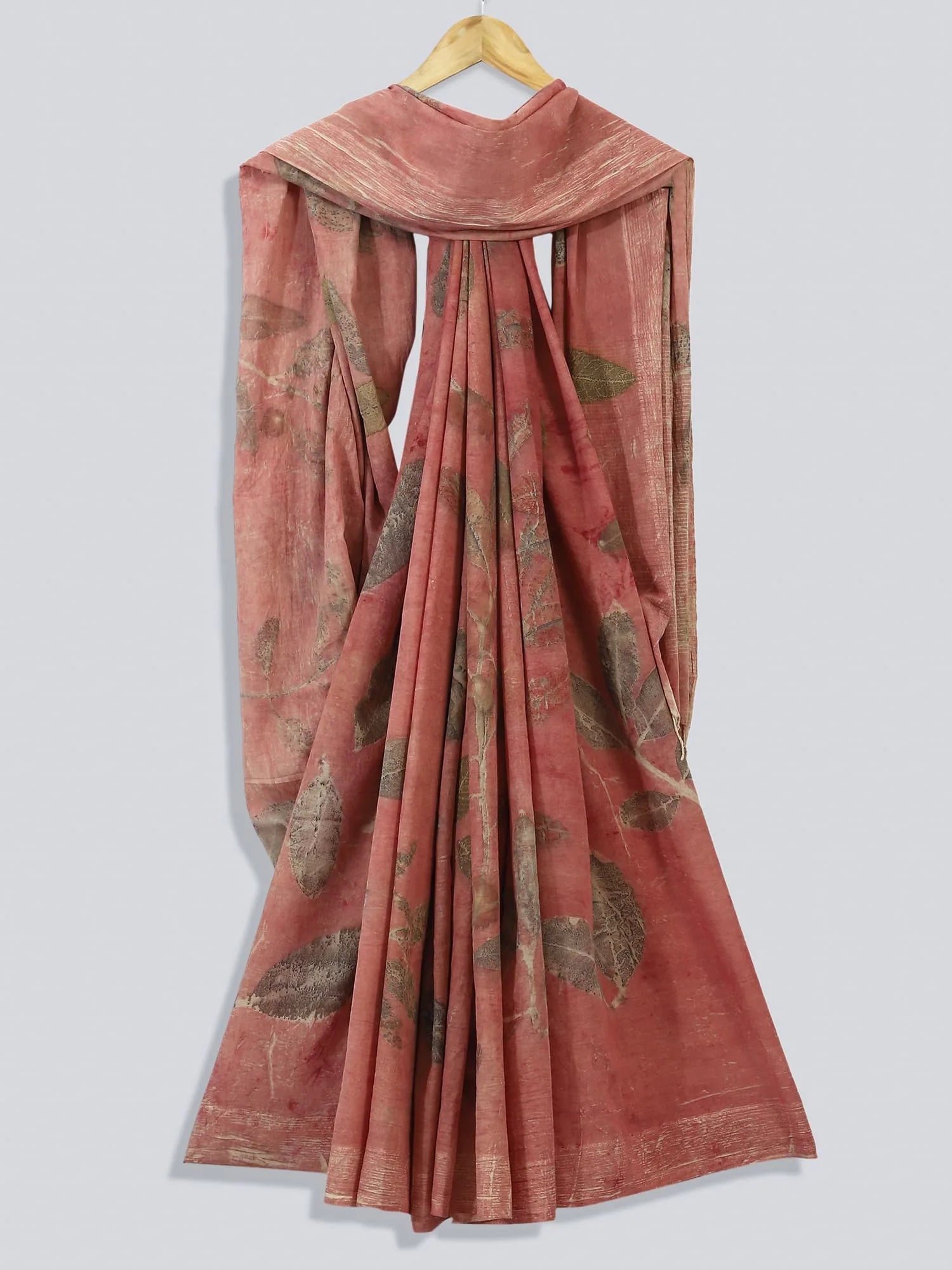 Pink saree with leaf patterns on a white background